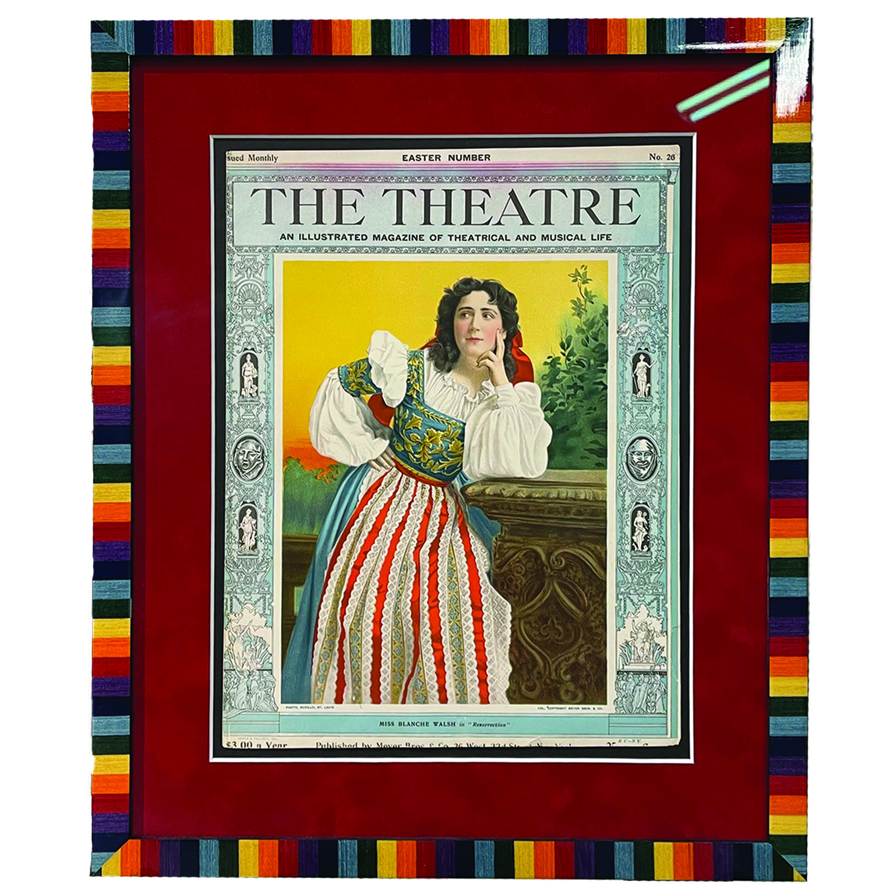 A vintage theatre print in rainbow custom frame with a red mat