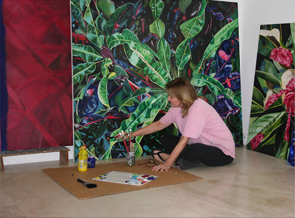 Artist Marcelle Zanetti in studio painting a large botanical piece
