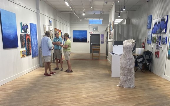 Karl Swan Norberg speaks with customers at the Maine Artists Collective