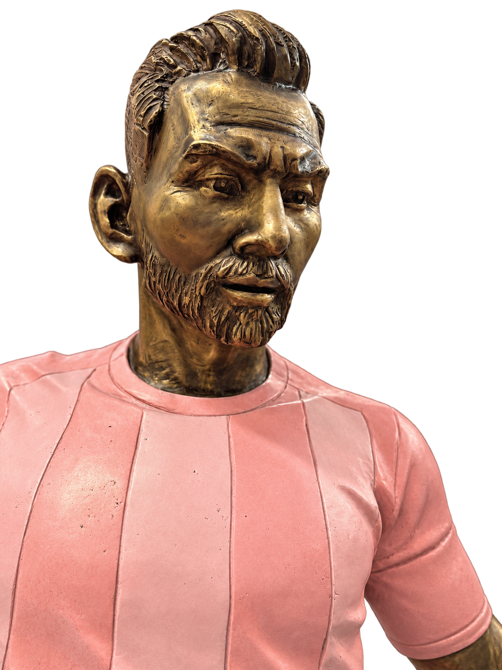 Matthew Snider Leo Messi sculpture: a bronze footballer in a pink uniform prepares to kick a ball on an oval bronze-colored base.