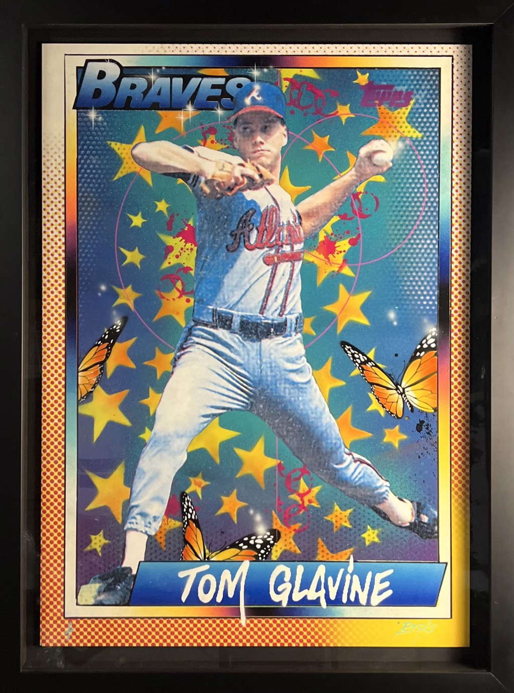 RISK Risk Topps Project 70 "Tom Glavine": Tom Glavine pitching beneath Braves lettering with yellow stars and orange butterflies on a teal-blue background.