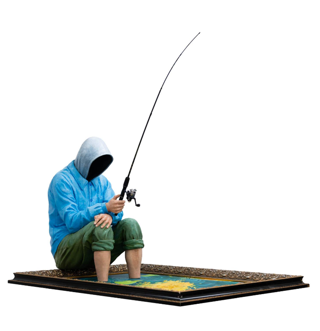 Hijack Hooked on Art sculpture: a seated figure in a blue hoodie holds a fishing rod above a framed painting.
