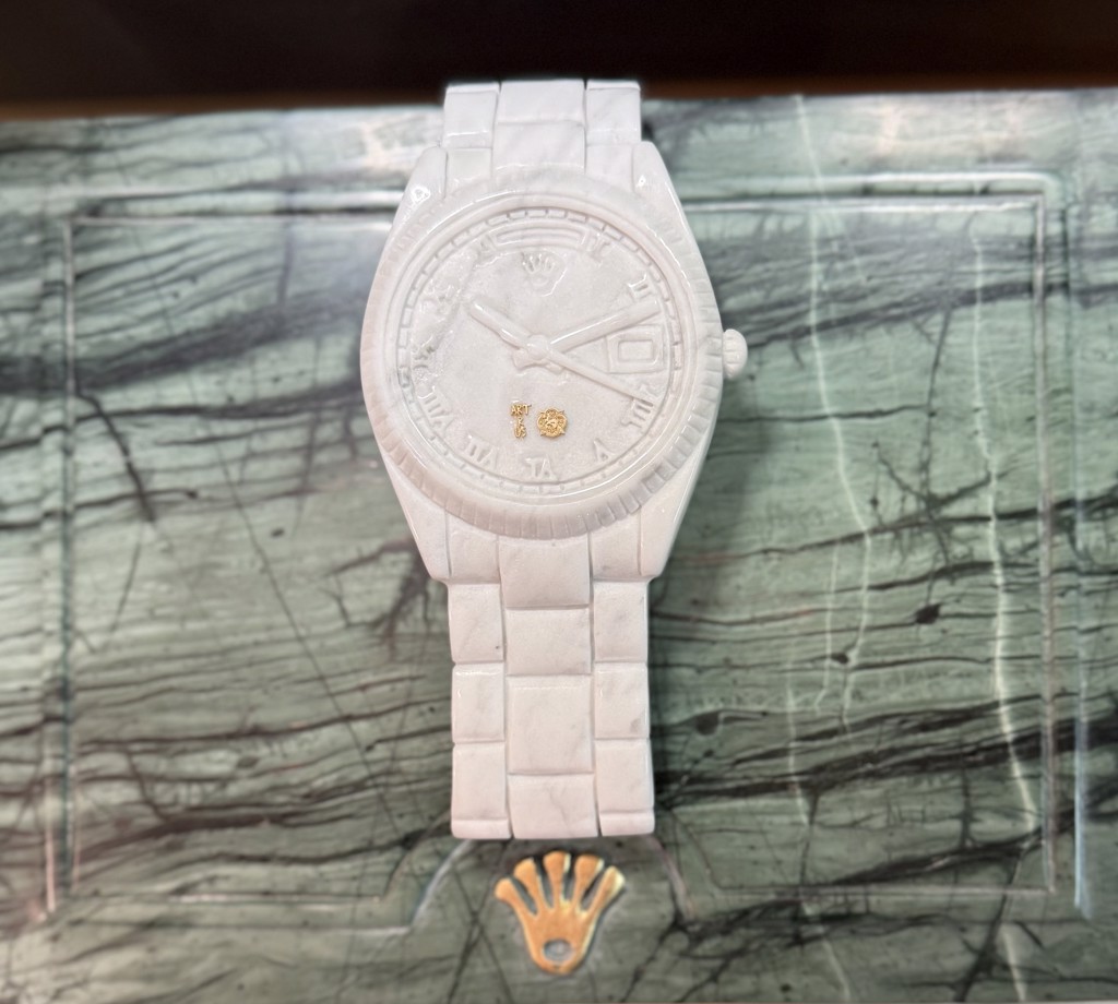 Ayden Snider Timeless Currency - TraxNYC Collab: white marble wristwatch against a green-veined marble presentation box.