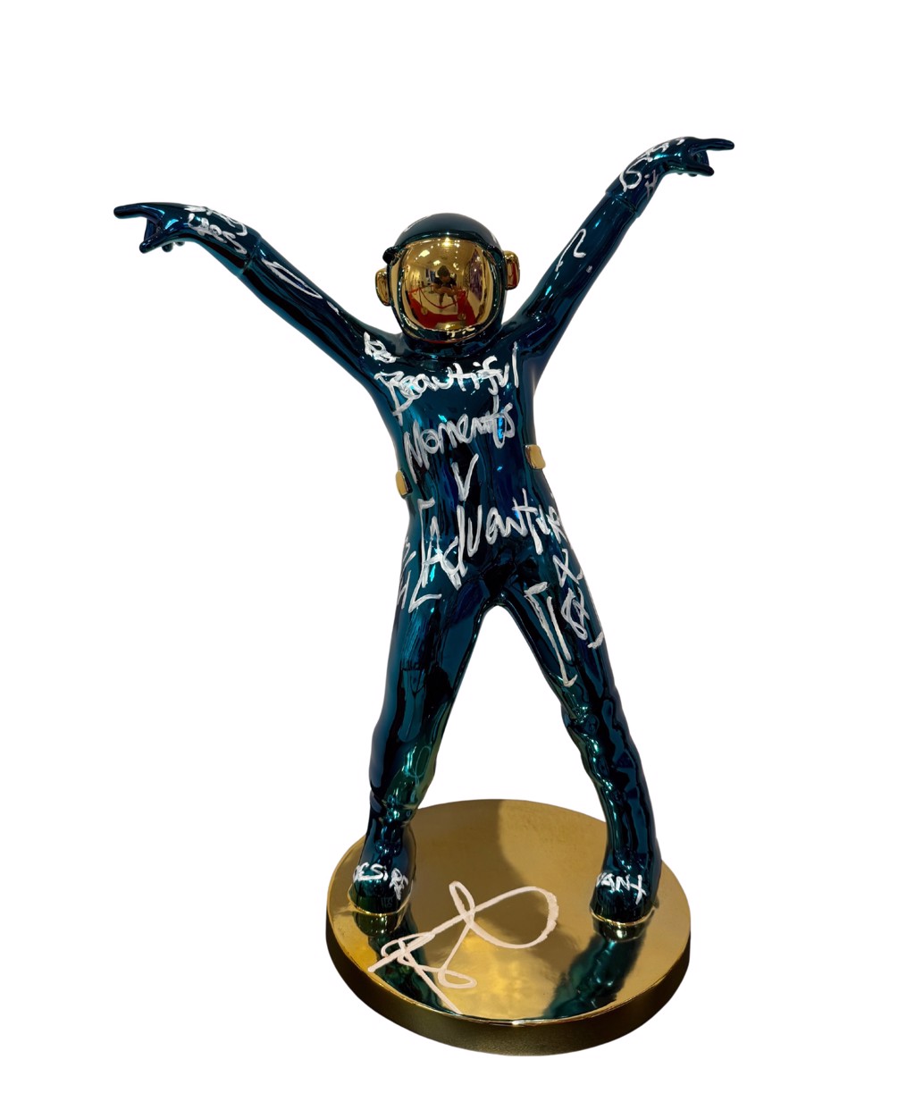 Brendan Murphy The Dancing Spaceman: dark teal-blue chrome astronaut with raised arms, white handwriting, gold-toned visor, and circular base.