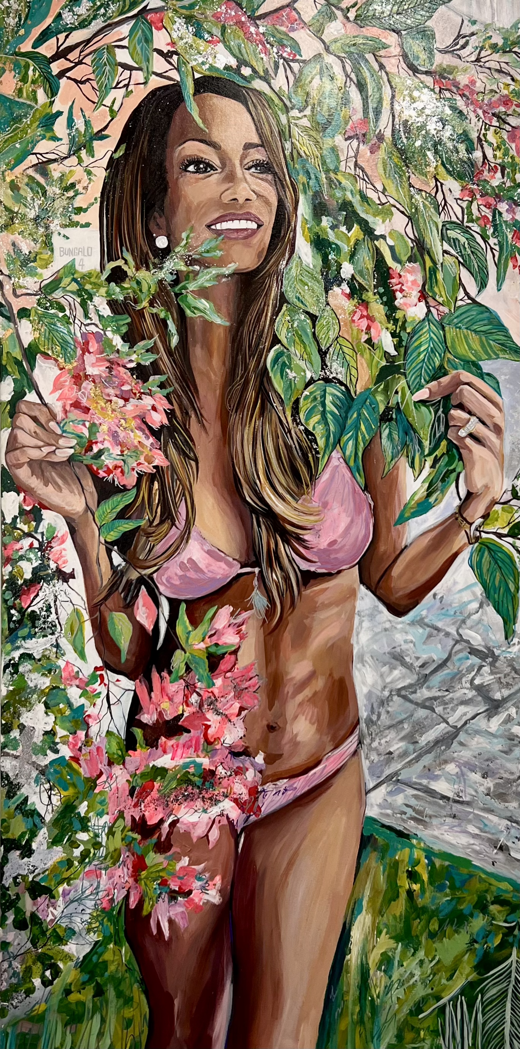 Julianne Marangi Katie "Lady in the Leaves": smiling woman in a pink bikini among green leaves and pink flowers.