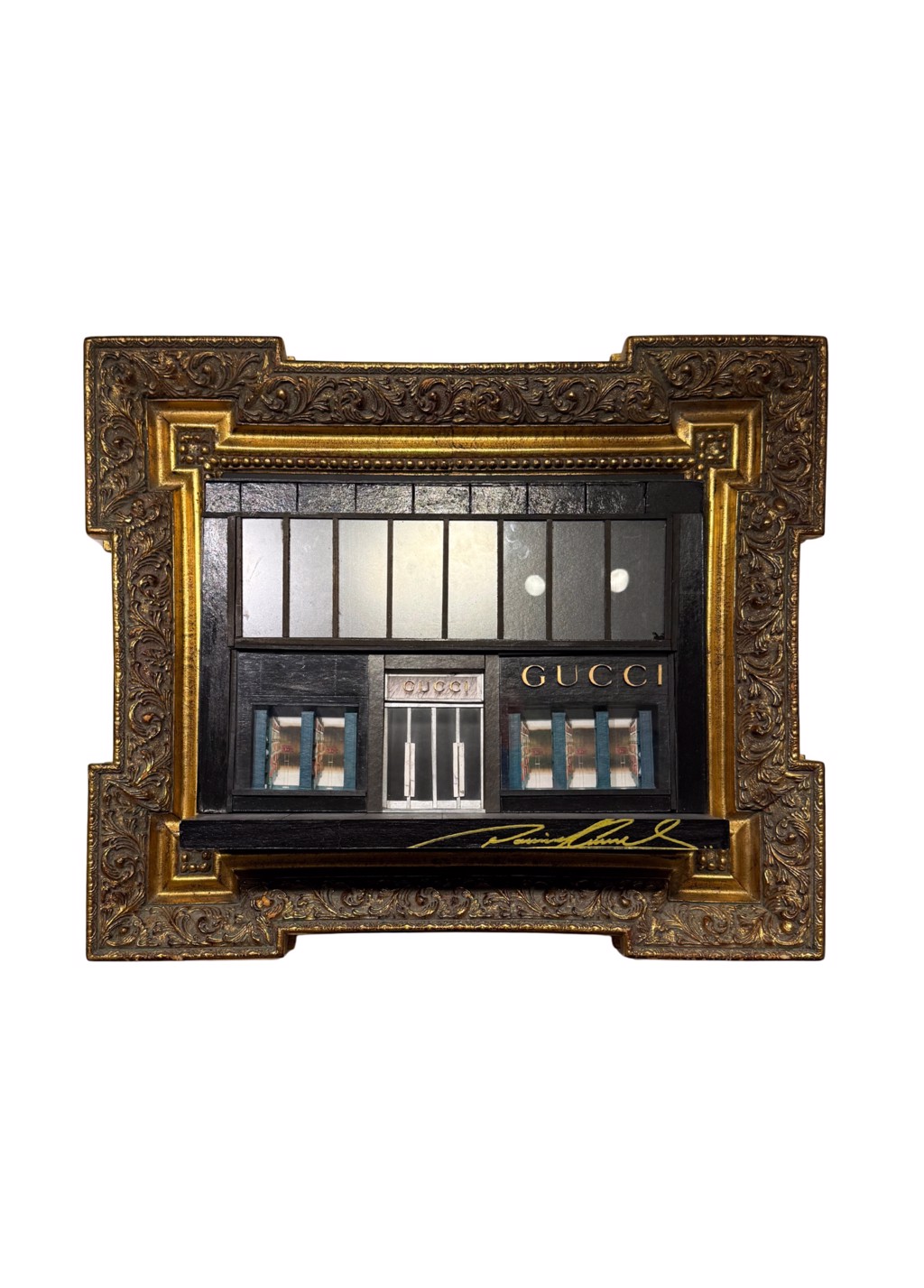 Danny Cortes Gucci: miniature dark Gucci storefront with display windows inside an ornate gold-toned frame.