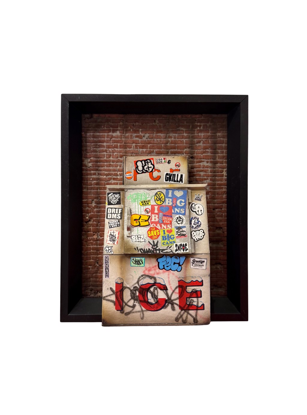 Danny Cortes Original Ice Box: weathered miniature ice box with red ICE lettering, stickers, and graffiti against brick inside a dark shadowbox.
