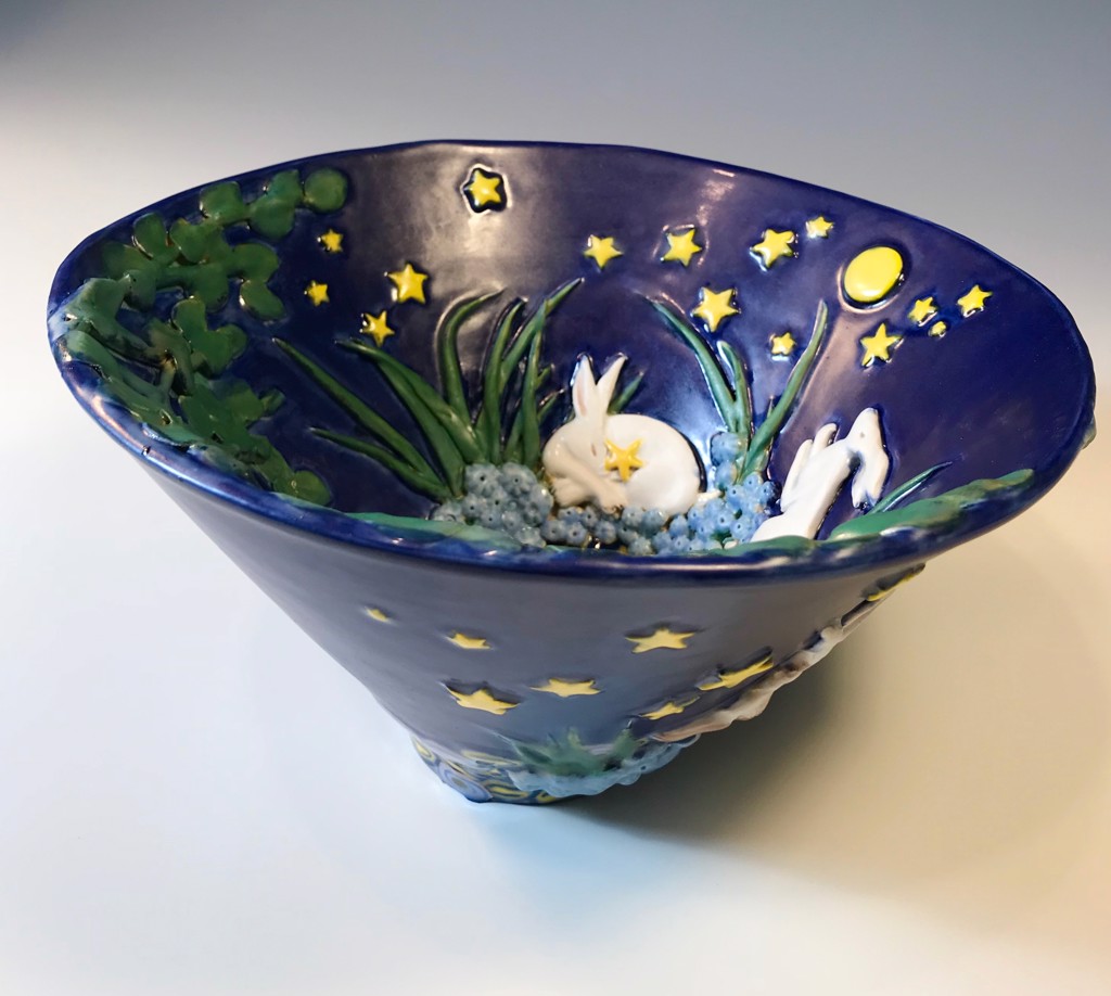 decorative bowl in dark blue with stars, moon, and bunnies