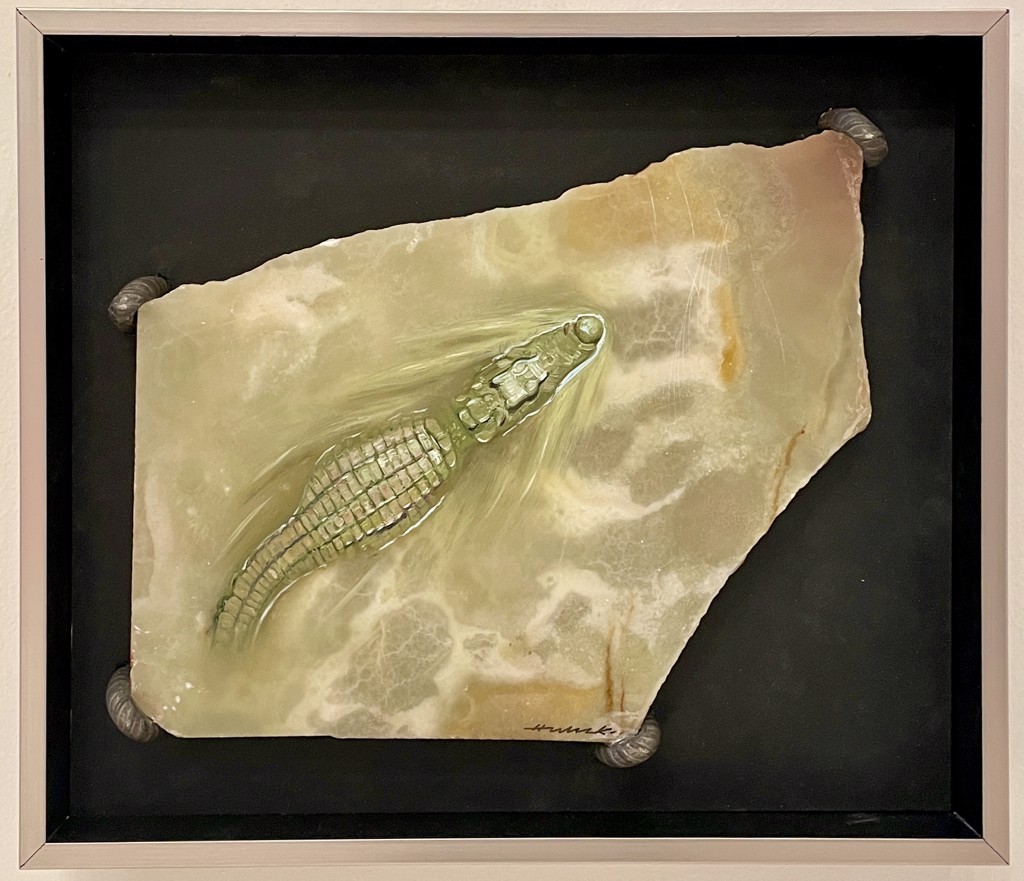 Hijack Alligator: green alligator painted on an irregular pale marble slab against a dark backing.