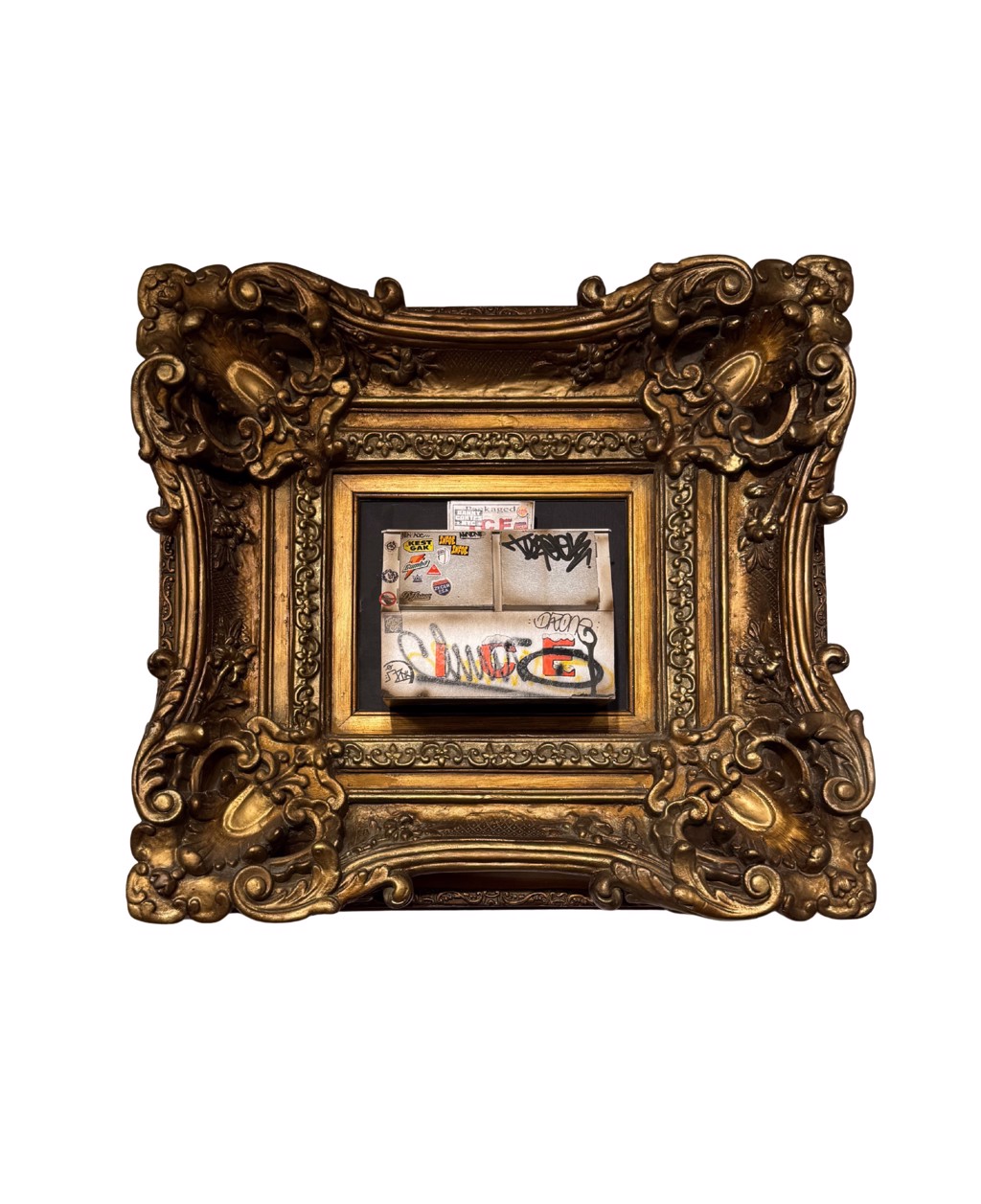 Danny Cortes Double Door Icebox: small white double-door icebox with graffiti and stickers inside a deeply ornamented gold-toned frame.