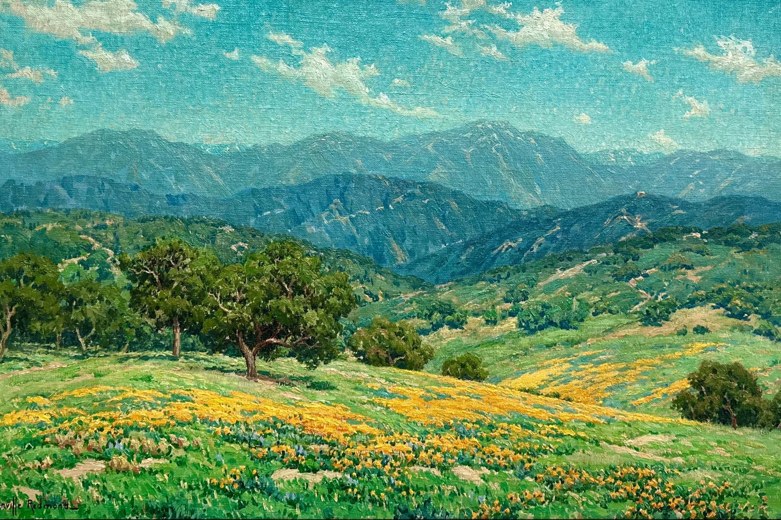 California Poppies In Bloom by Granville Redmond, c. 1924-1928, oil on canvas painting of green hills with golden poppy fields below blue mountains