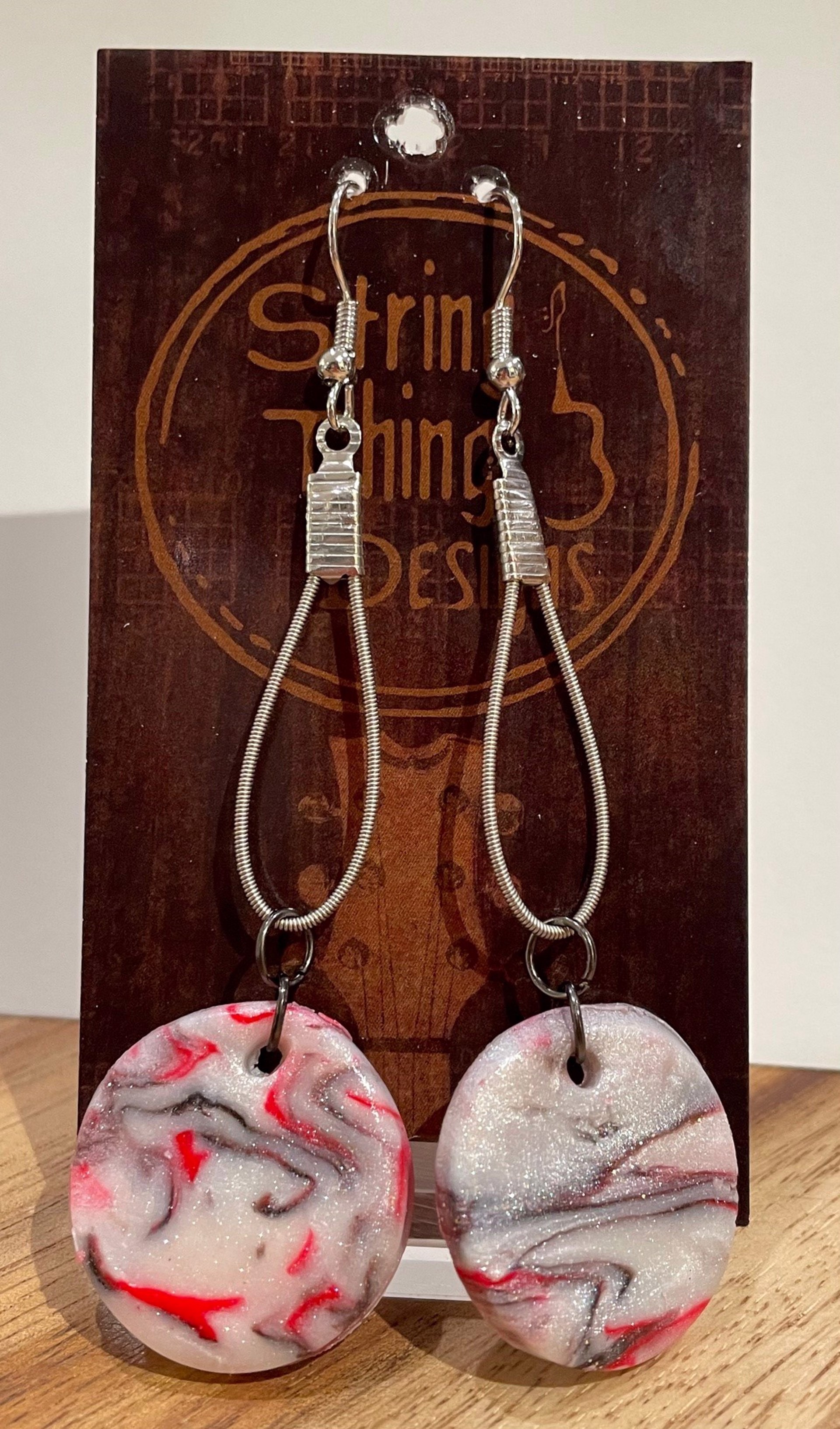 White, Red, and Black Guitar String Earrings by String Thing Designs