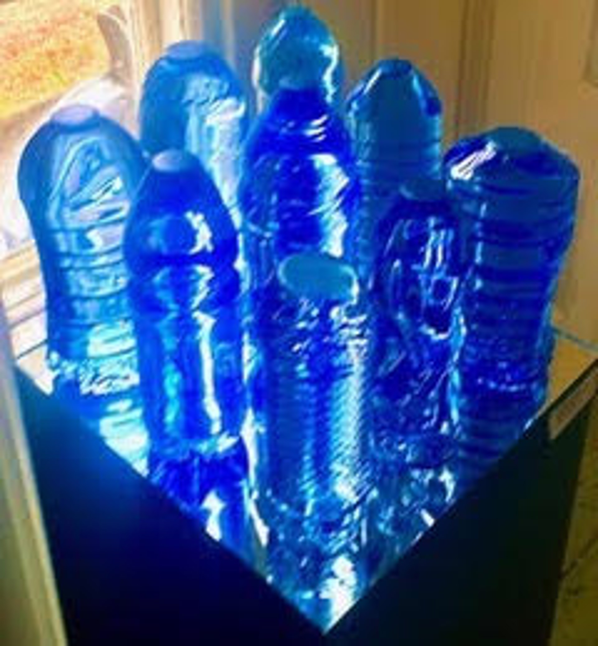 9 Cast plastic bottles by Robert Rindler