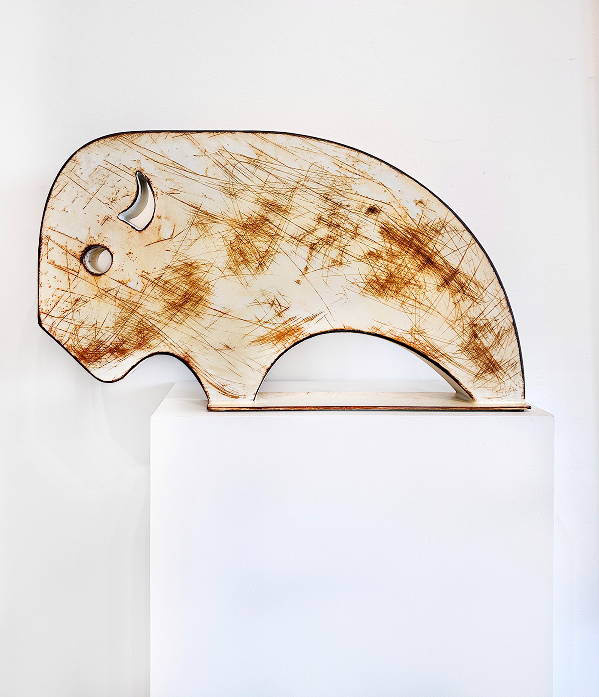 Steel Sculpture Of A Walking Bison In Simplified Shapes With White Rusted Finish