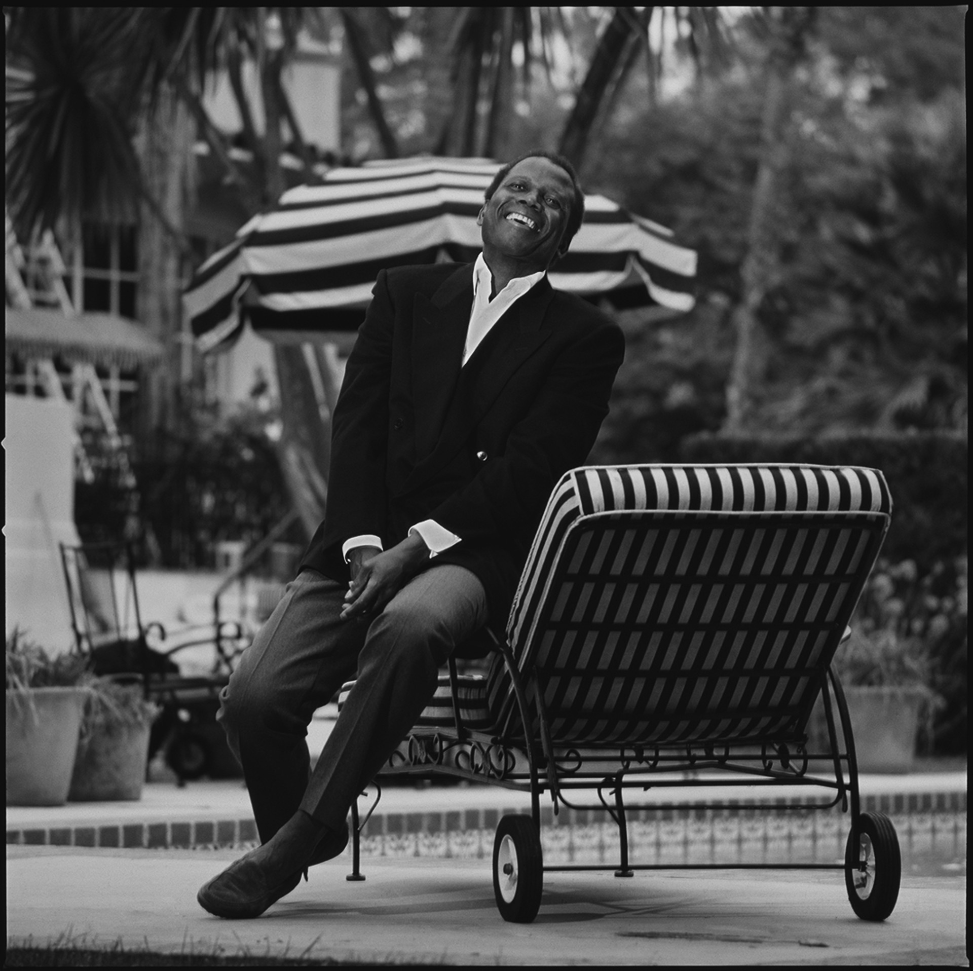 87125 Sidney Poitier Laughing on the Chaise BW by Timothy White