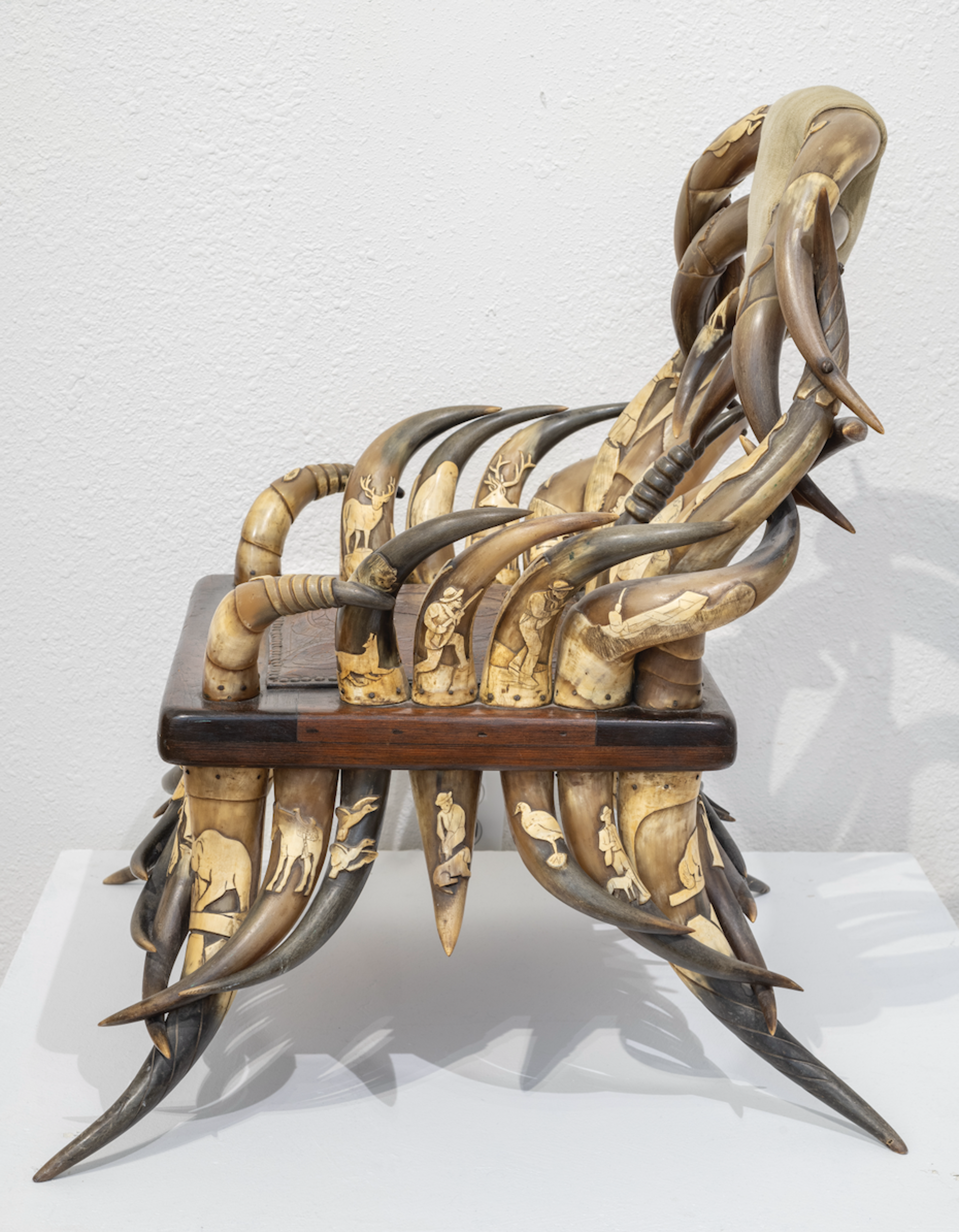 DS-1: Carved longhorn child's chair; 51 carved horns, with tooled leather seat by Dan Super