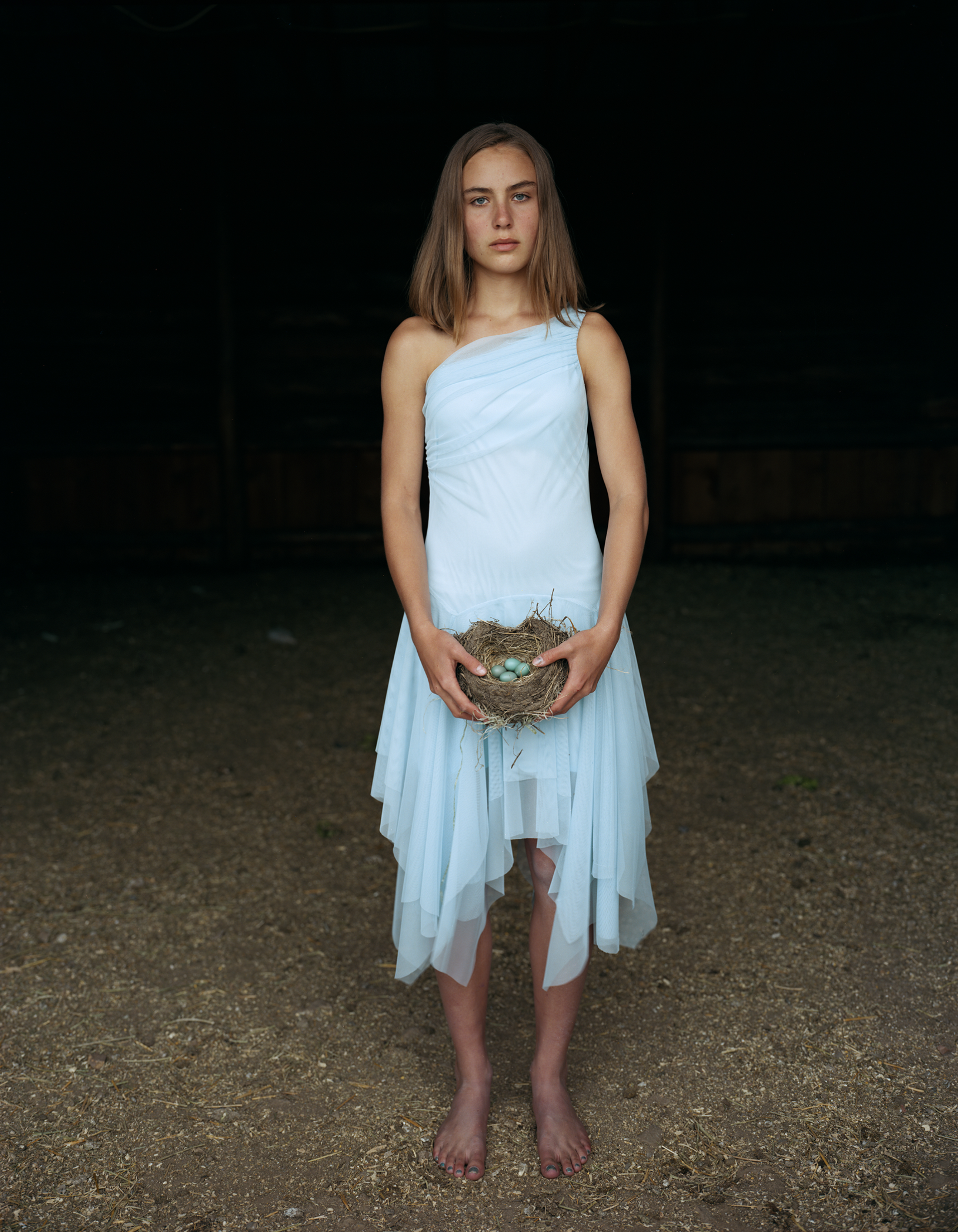 Mattie Holding a Robin's Nest, in Her Eighth Grade Graduation Dress  Laverty Ranch, May 2005, Idaho by Laura McPhee
