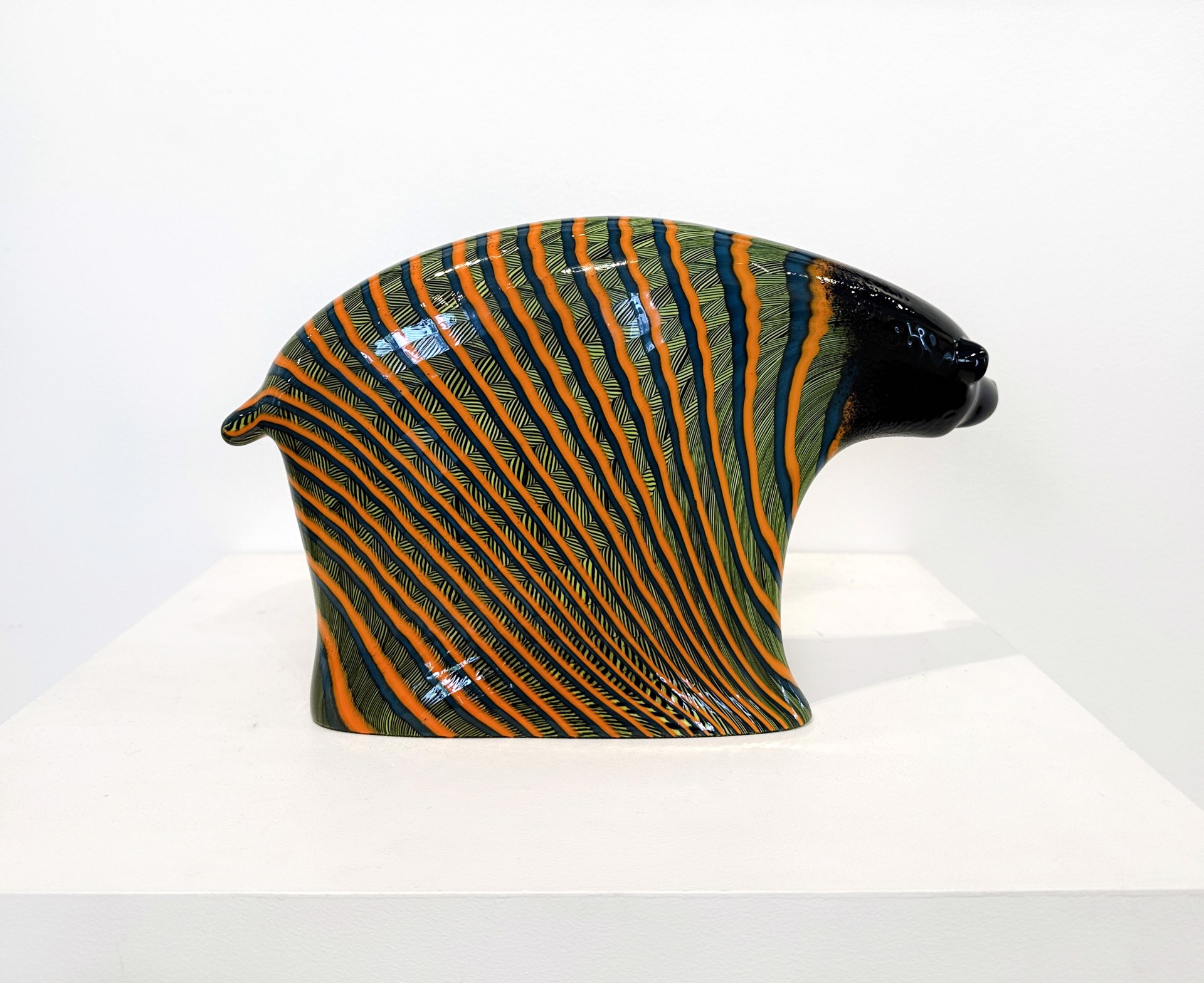 Original Hand Blown Glass Sculpture By Dan Friday Featuring A Simplified Bear Form With Orange And Green Lightning Pattern Motif Over Deep Glossy Black