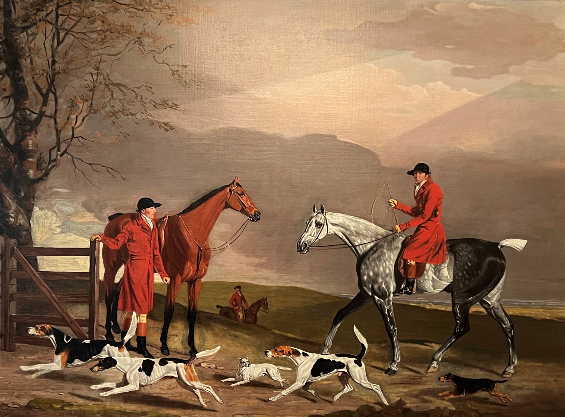 Thomas Oldaker on a grey hunter, with other huntsmen, hounds and terriers, in a landscape by Benjamin Marshall