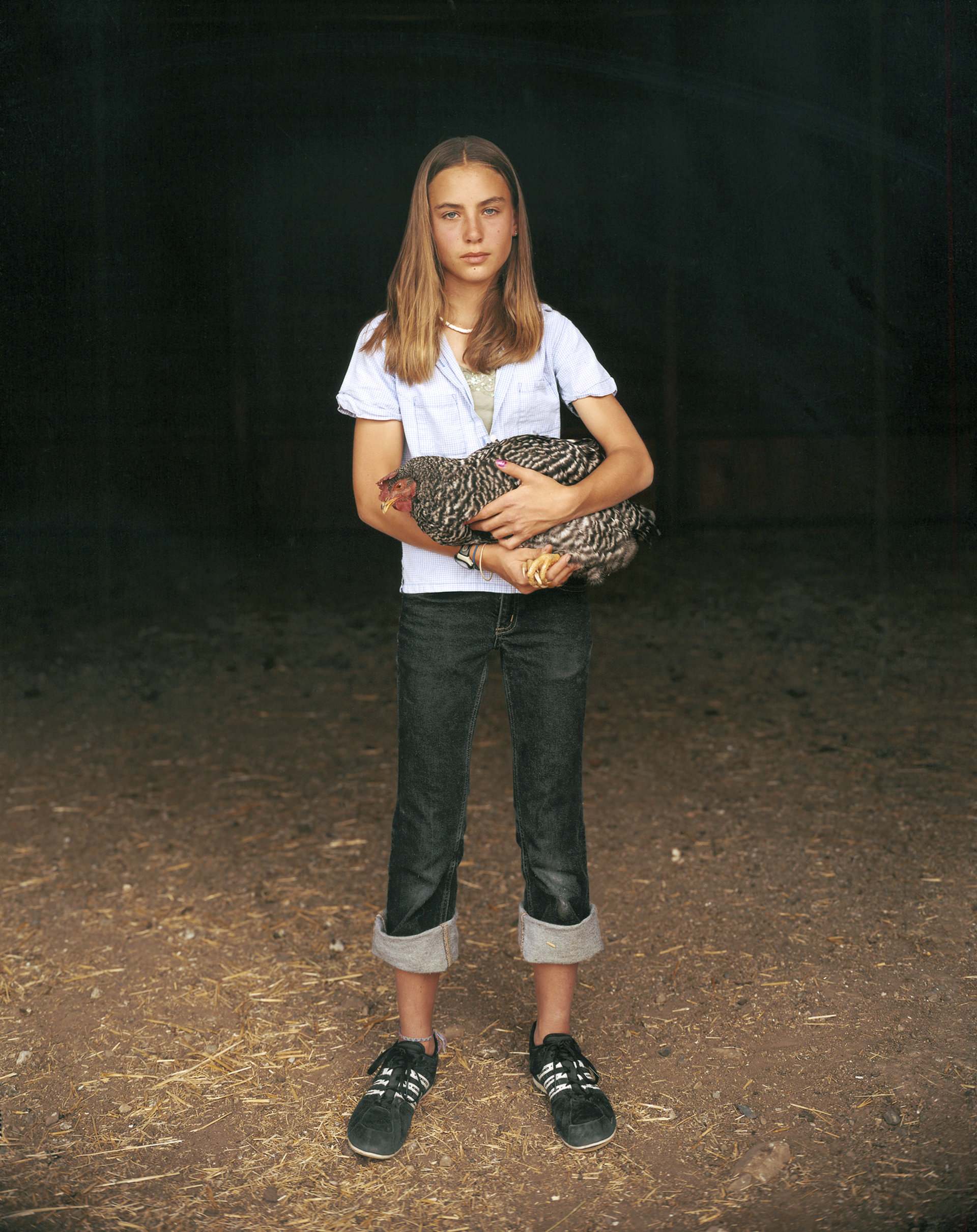 Mattie with a Plymouth Barred Rock Hen, Laverty Ranch, Custer County, Idaho by Laura McPhee