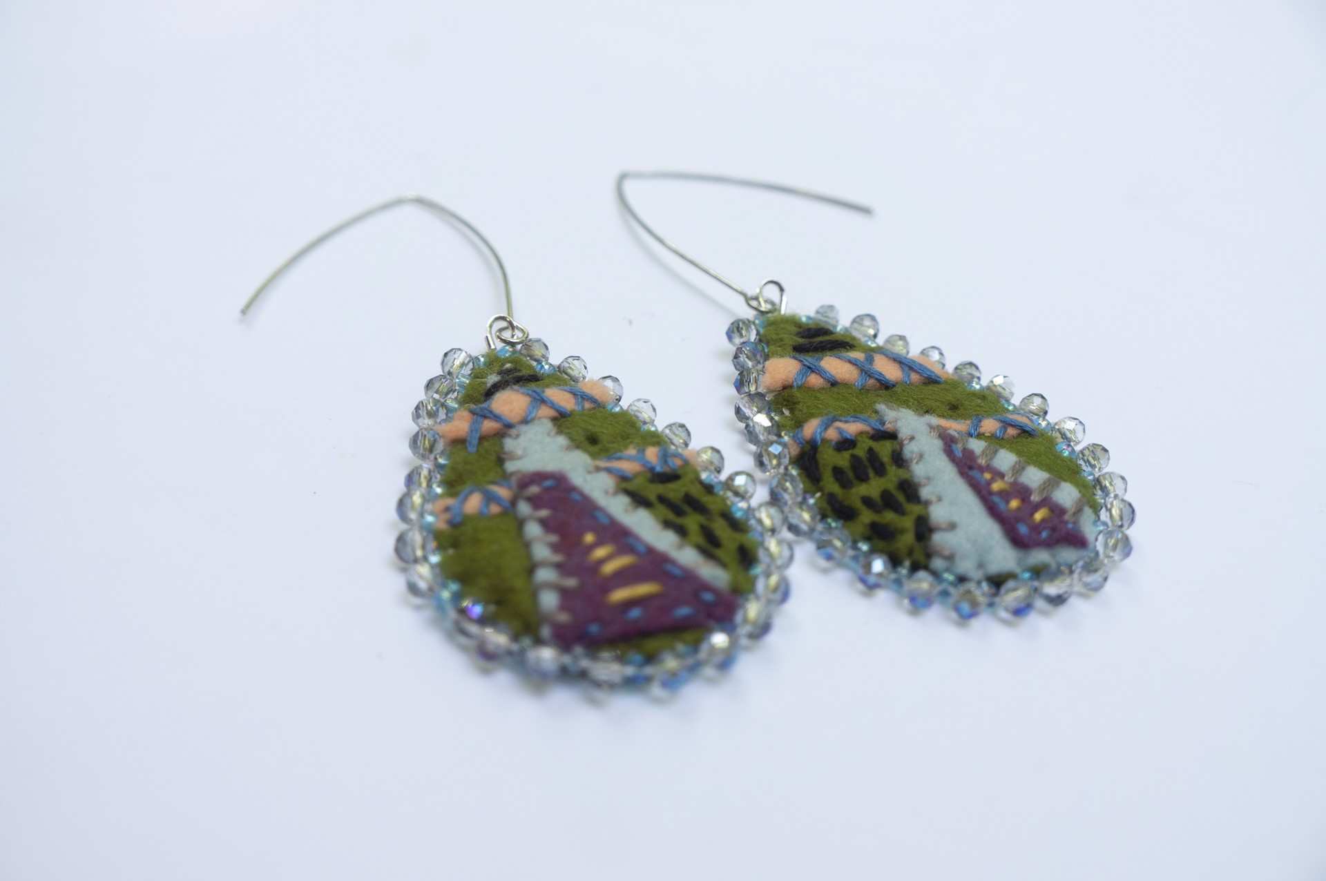 Green, blue edged, embroidered earrings by Hattie Lee Mendoza