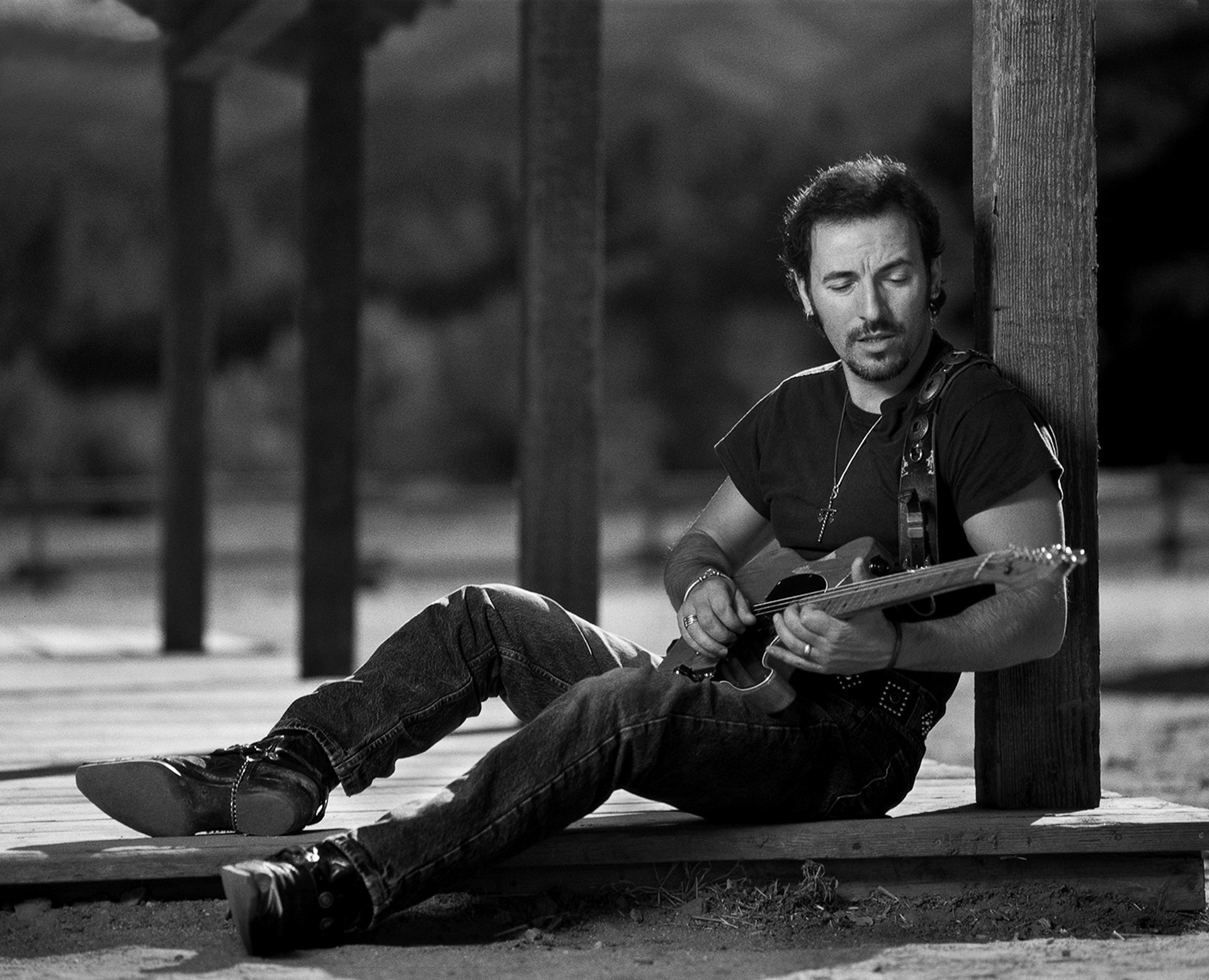 91152 Bruce Springsteen Playing Guitar Sitting Against Pillar BW by Timothy White