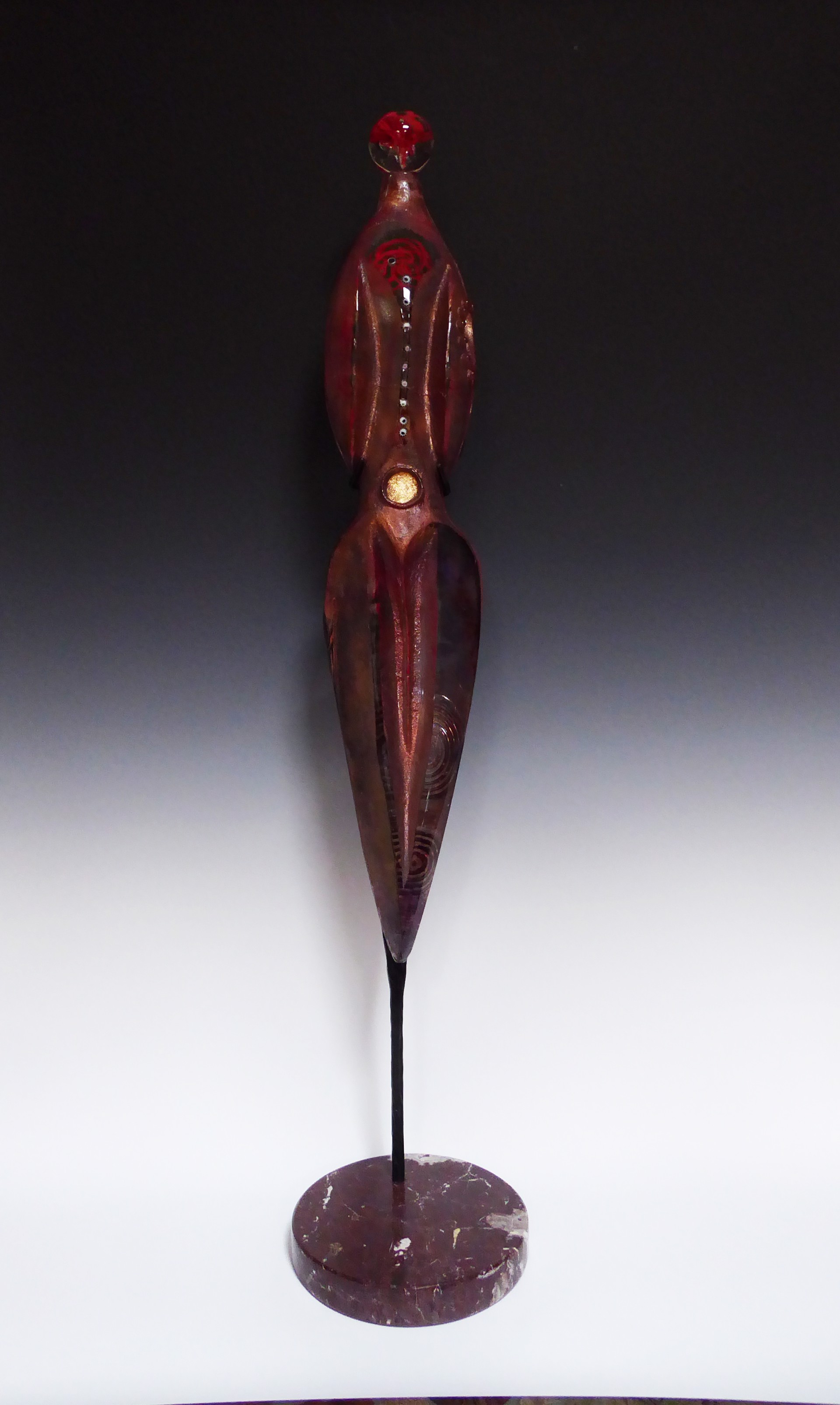 Red Sister ~ Cast female figure which hangs in metal bracket with stone base.  by Susan Gott
