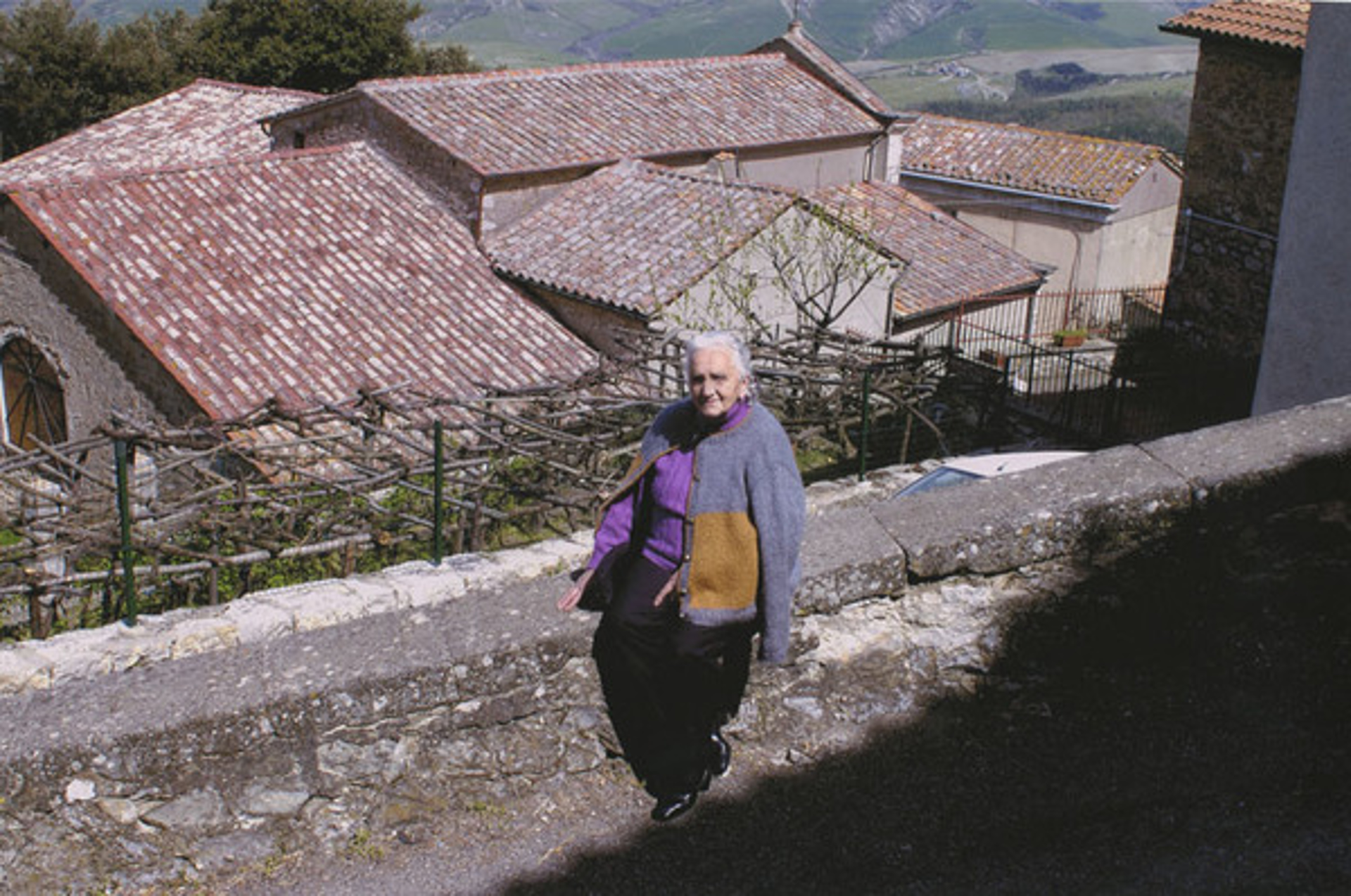 Woman w/Rooftops, Campiglia D'Orcia, Italy by Murray Weiss