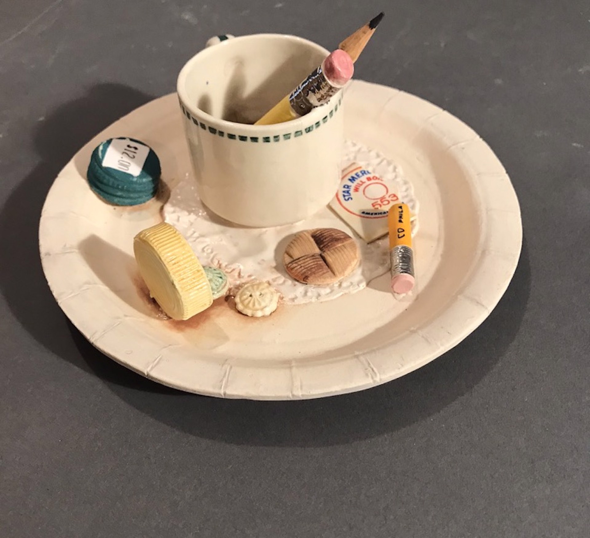 Teacup with Pencils on Paper Plate by Richard Shaw