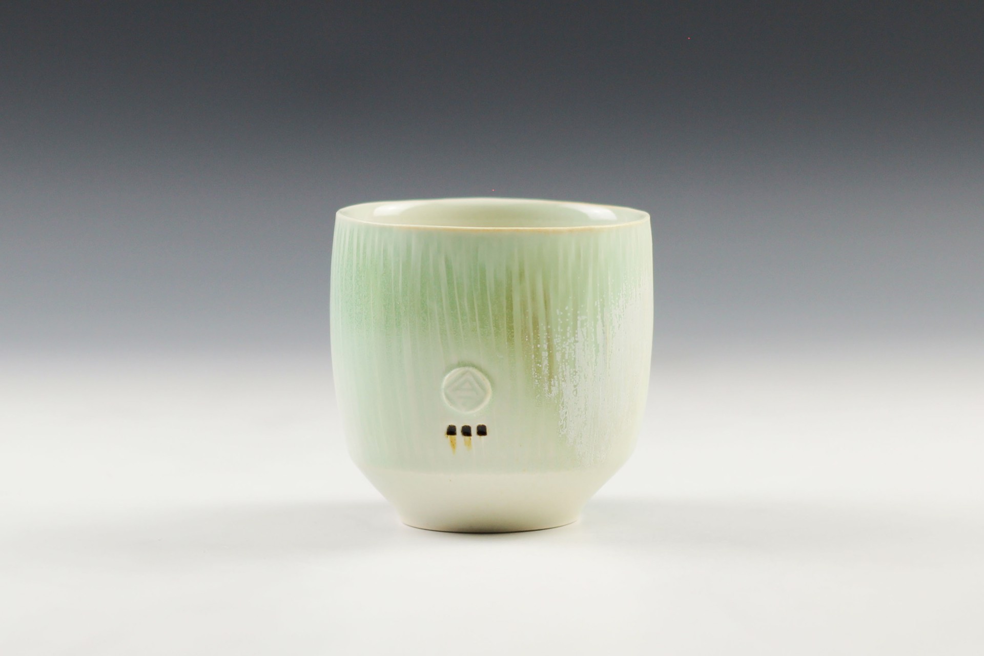 Round White and Green Cup by Nick DeVries