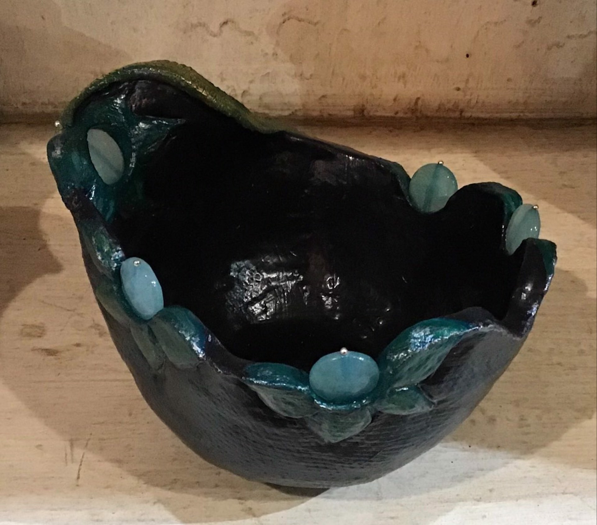 Black Bowl, Green Flowers and Blue Stones by Nancy Burns
