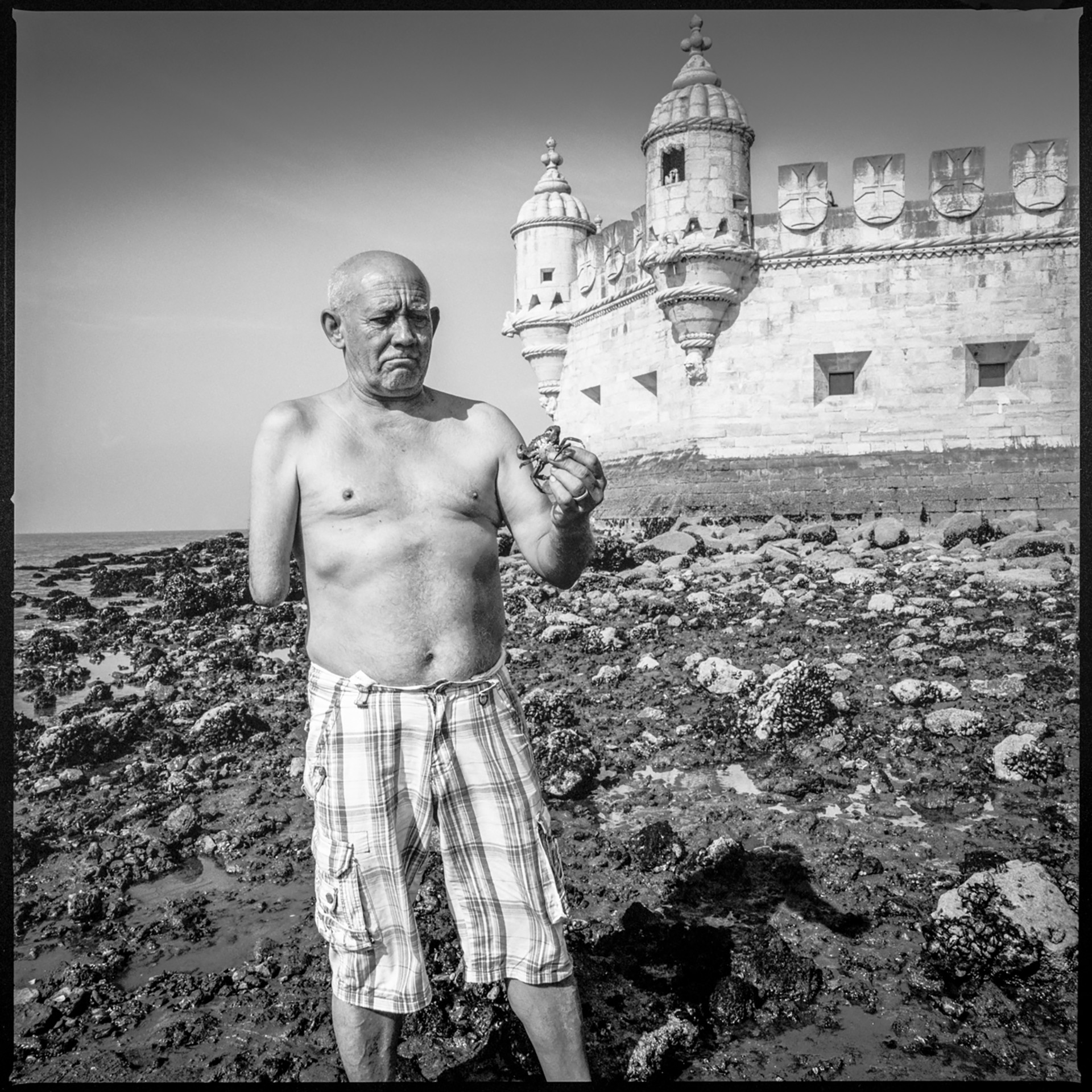 Man on Shore - Lisbon, Portugal by Kevin Greenblat