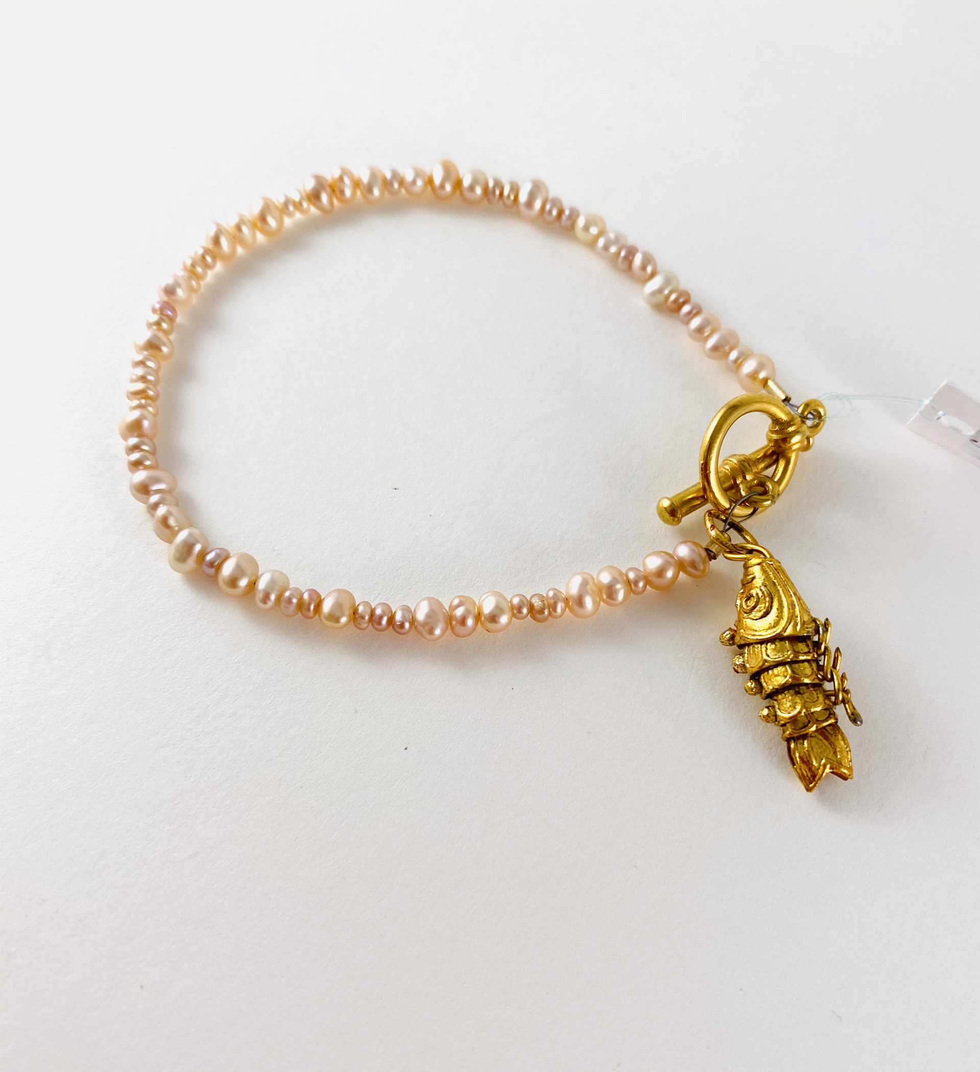 Peach Tiny Pearl Bracelet, Brass Toggle and Charm P7 by Nance Trueworthy