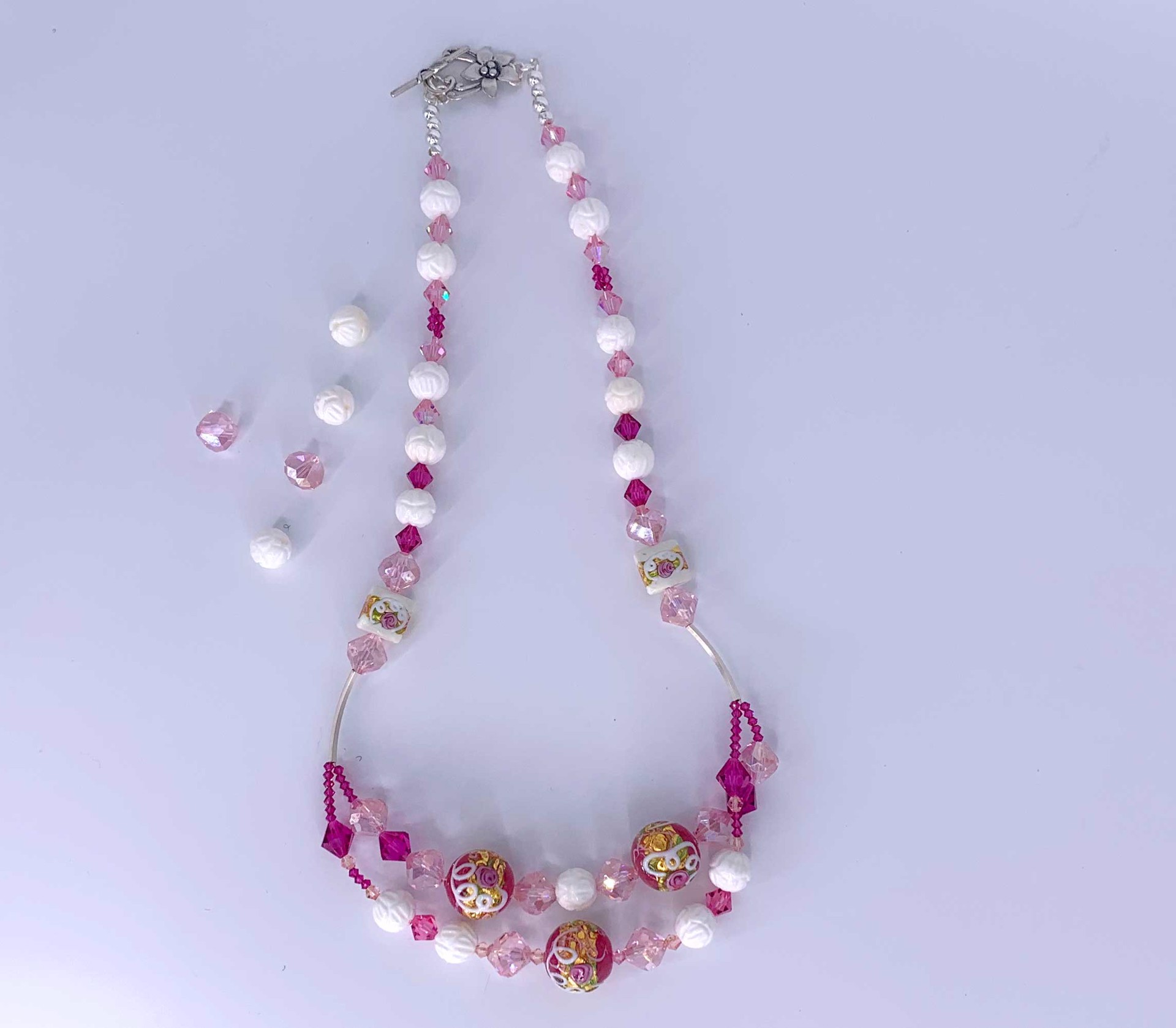 The delicately carved Tridacna shell beads, Venetian glass beads, Swarovski crystals lift this necklace to an elegant place in your wardrobe.