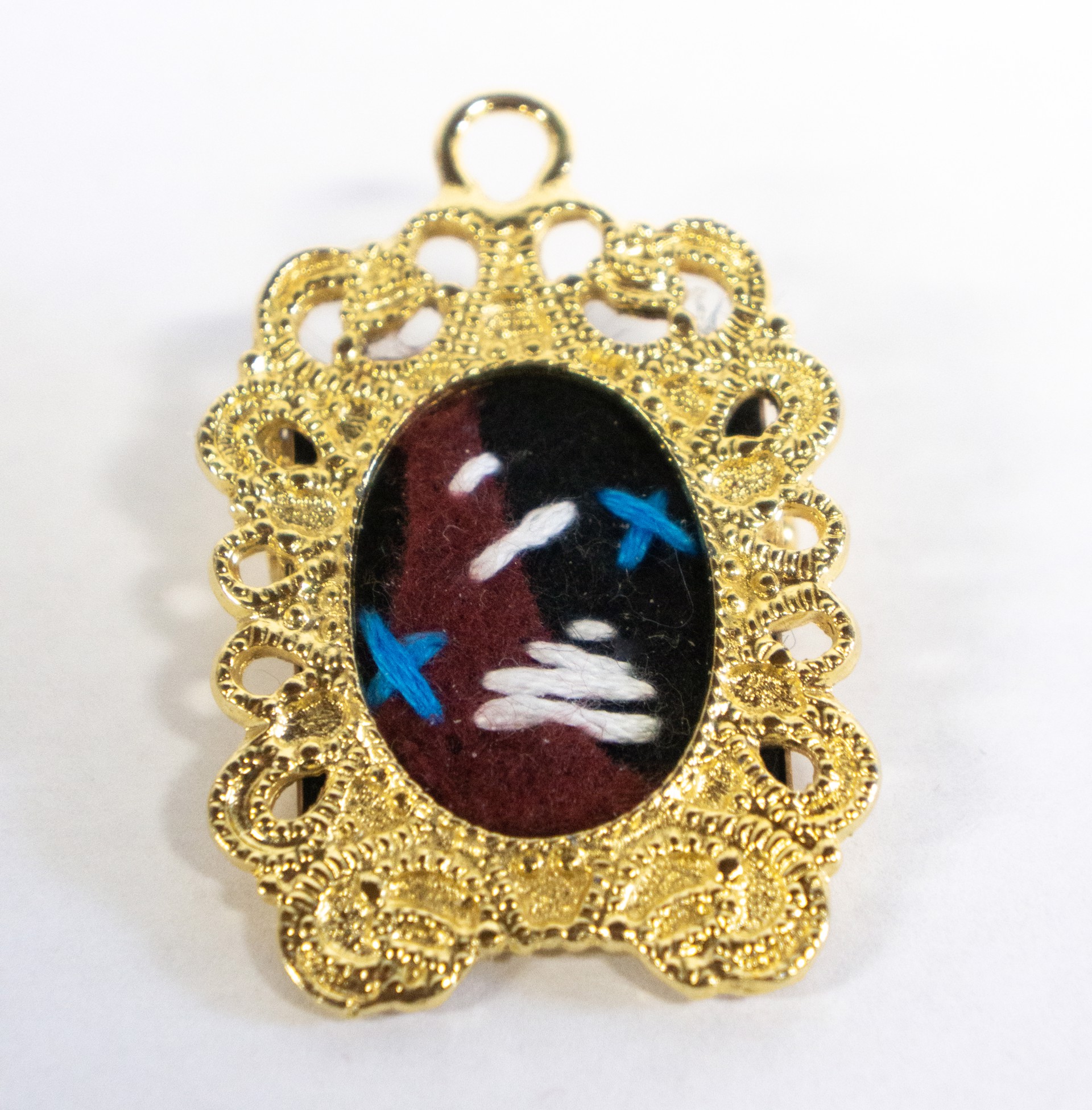 metal and embroidery brooch by Hattie Lee