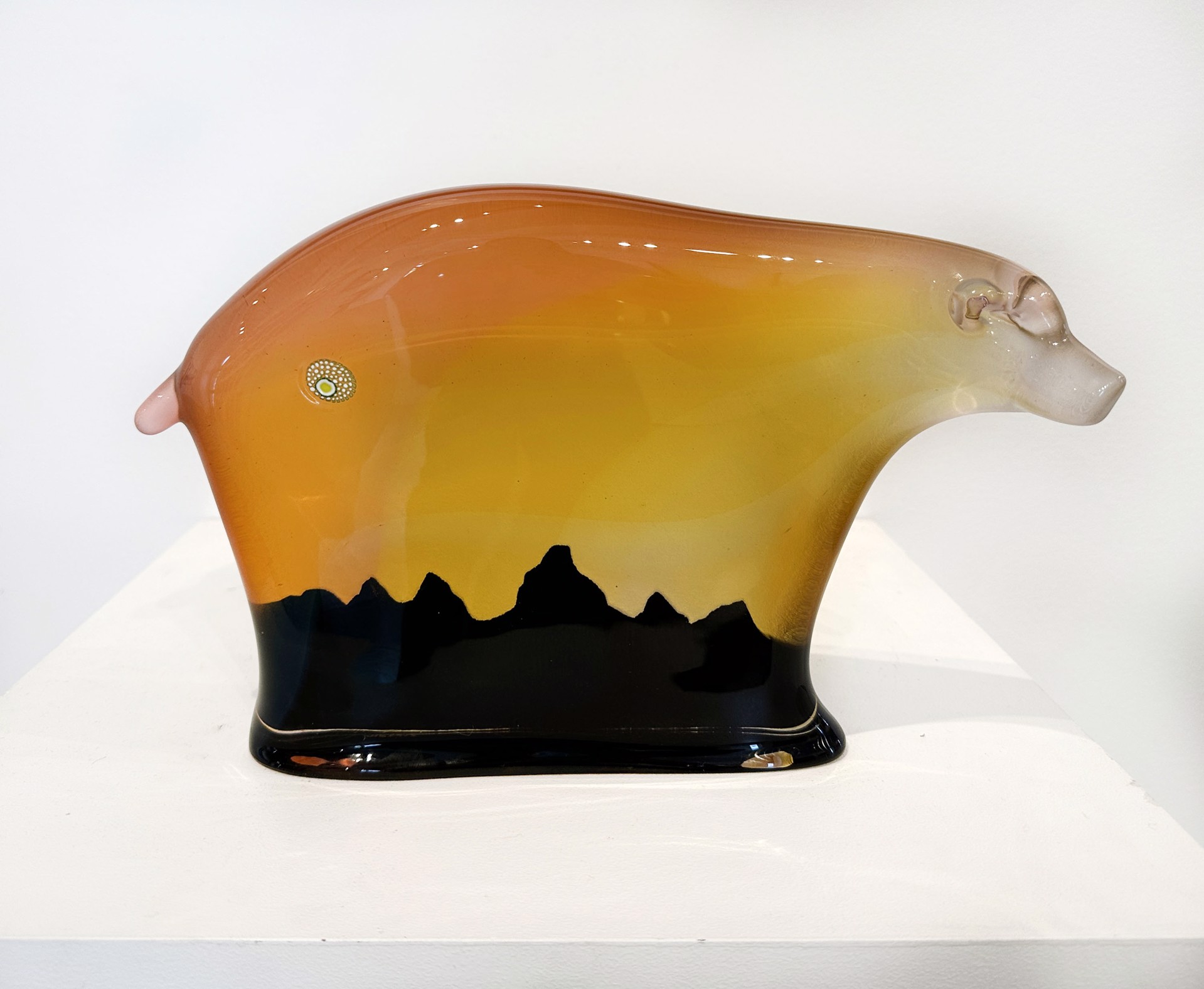 Original Glass Blow Sculpture By Dan Friday Featuring An Abstracted Bear Form In Orange To Yellow Gradient With The Teton Mountain Range Silhouette In Deep Purple
