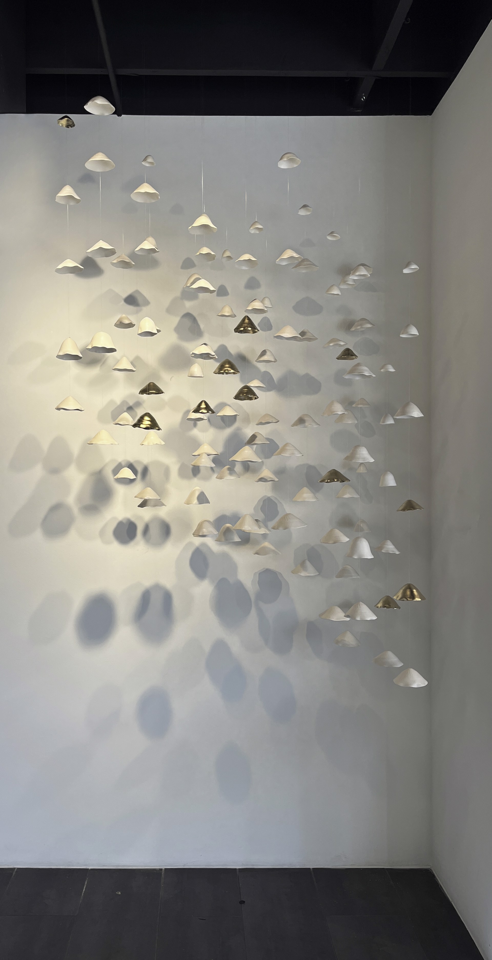Lucrecia Waggoner Porcelain Wall Installation Custom Artwork Lucrecia Waggoner Floating Garden, 2022 Polished porcelain with moongold, suspended on wire7 x 4 x 2 ft