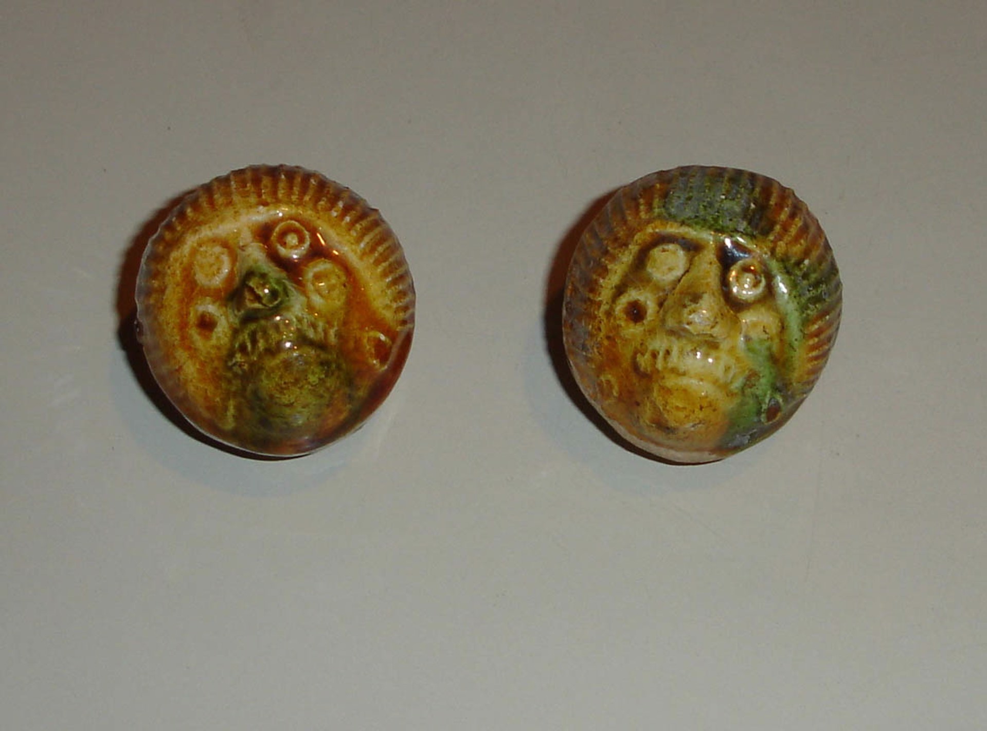 PAIR OF GLAZED POTTERY FIGURAL WHISTLES