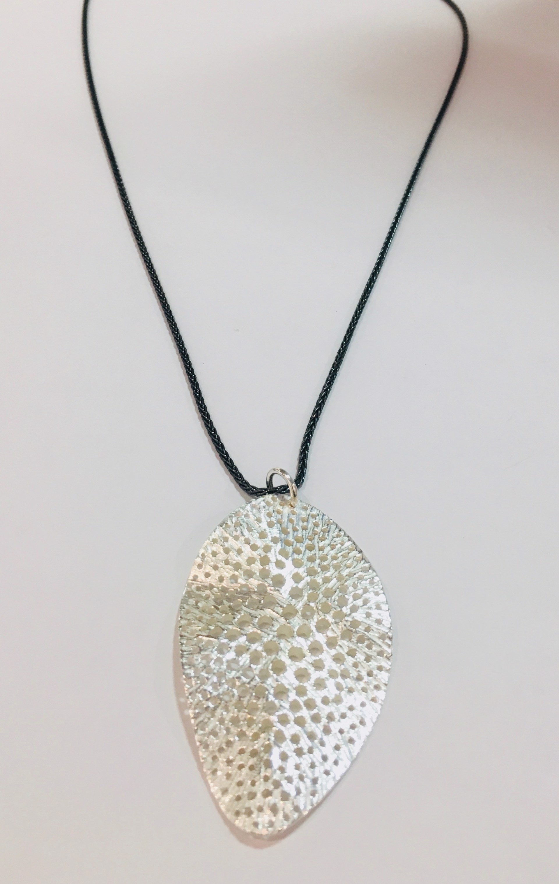 large ss pendant with holes by DAHLIA KANNER