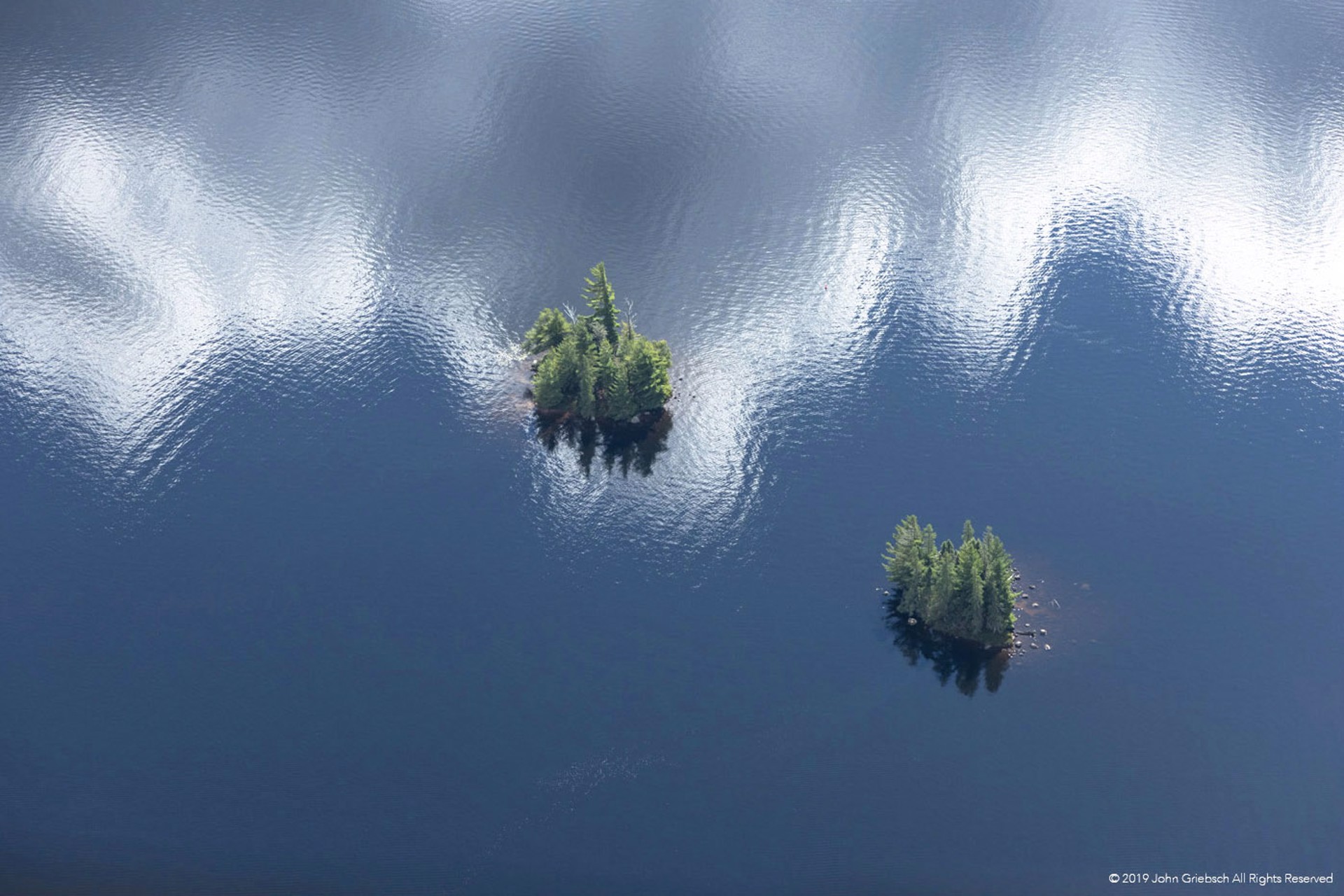 Two Islands and Cloud Reflections, Cranberry Lake, NY by John Griebsch