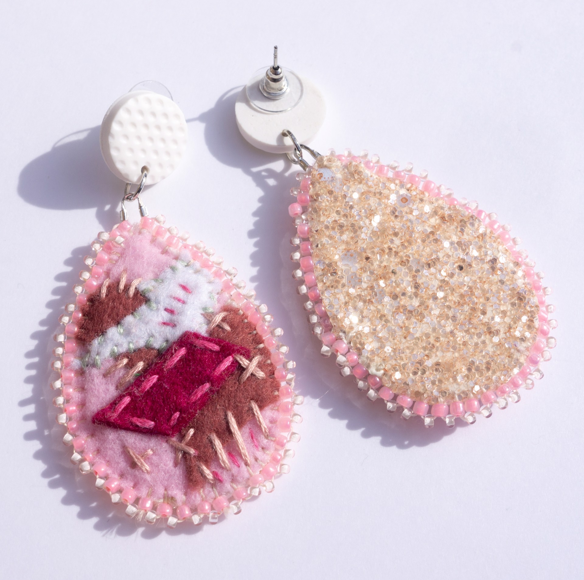 Pink embroidered earrings with white studs by Hattie Lee Mendoza