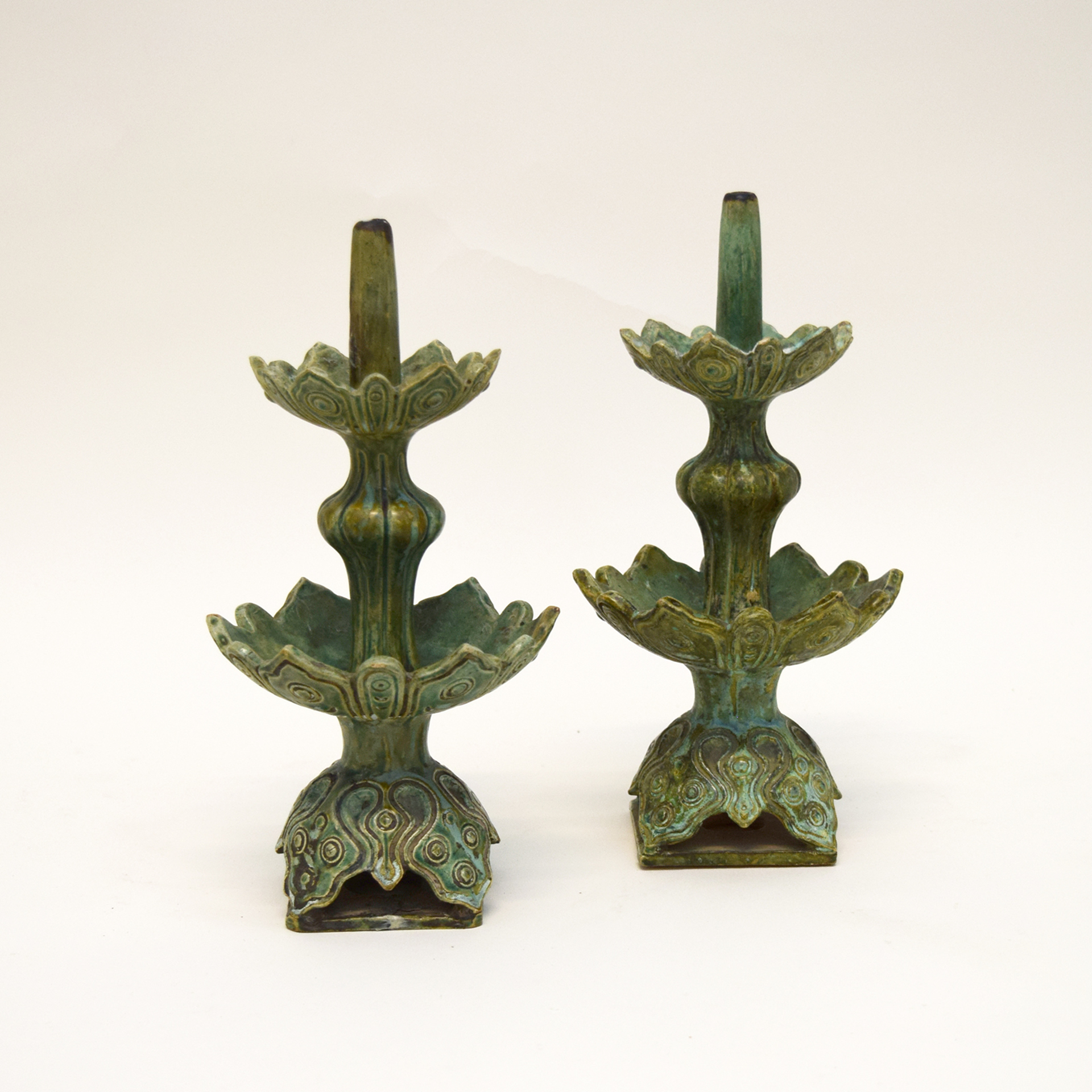 PAIR OF GREEN GLAZED POTTERY PRICKET CANDLESTICKS