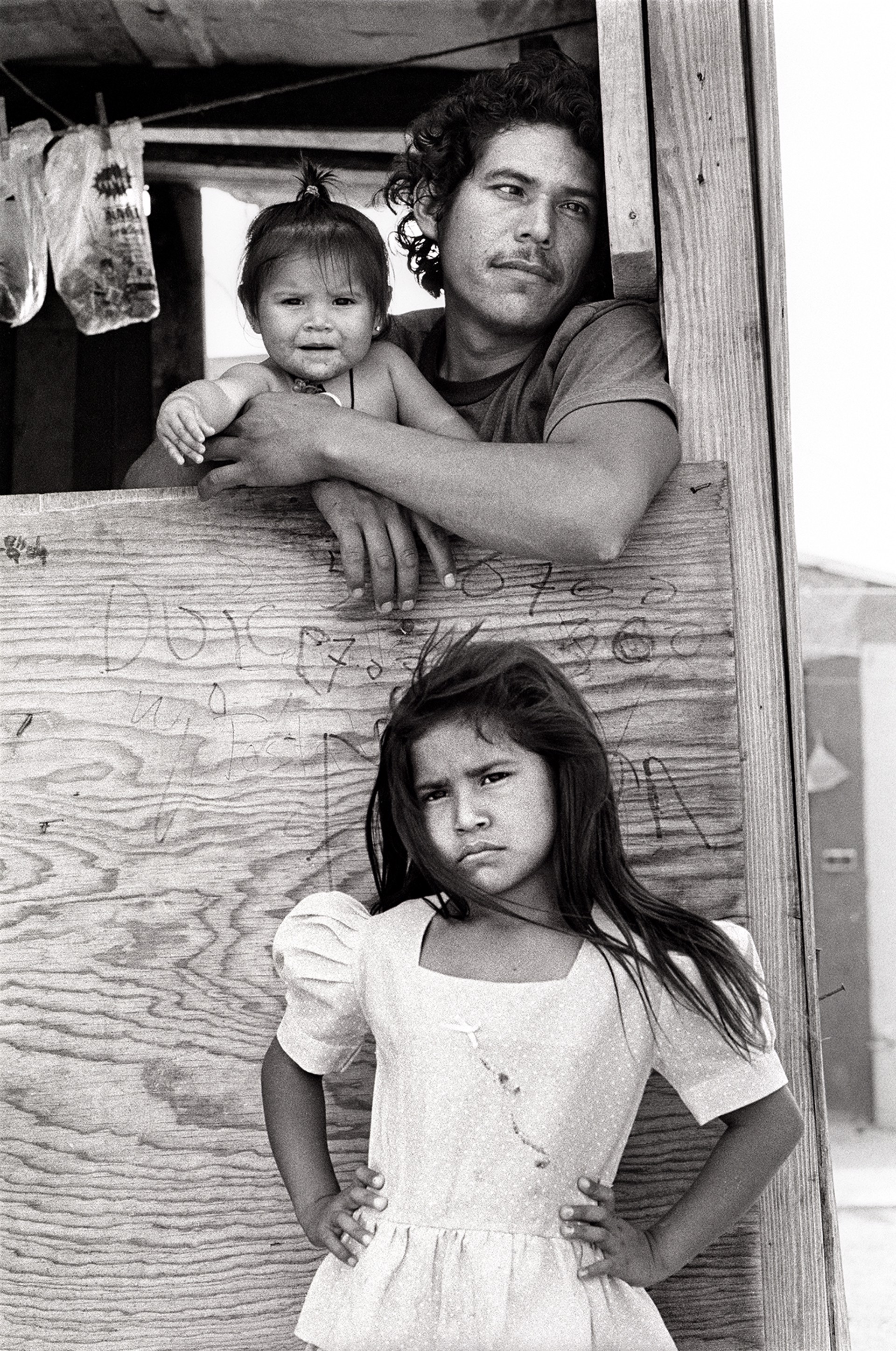 Child with Father and Sister, Colonia, Nuevo Laredo\Mexico, April 19, 1993   1/10 by Laura Wilson