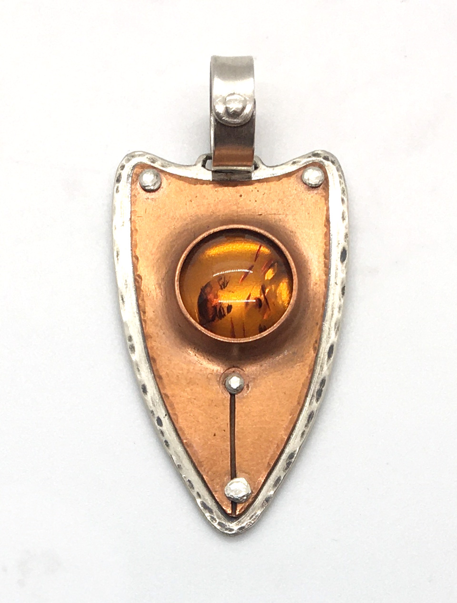 Silver and Copper Riveted Baltic Amber Pendant by Grace Ashford
