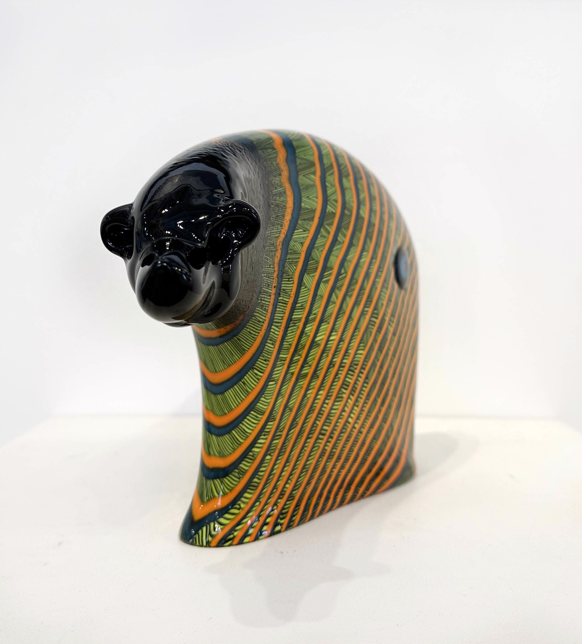 Original Hand Blown Glass Sculpture By Dan Friday Featuring A Simplified Bear Form With Orange And Green Lightning Pattern Motif Over Deep Glossy Black