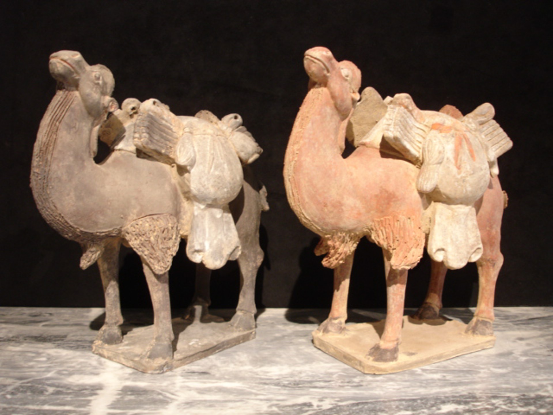 PAIR OF PAINTED POTTERY CAMELS