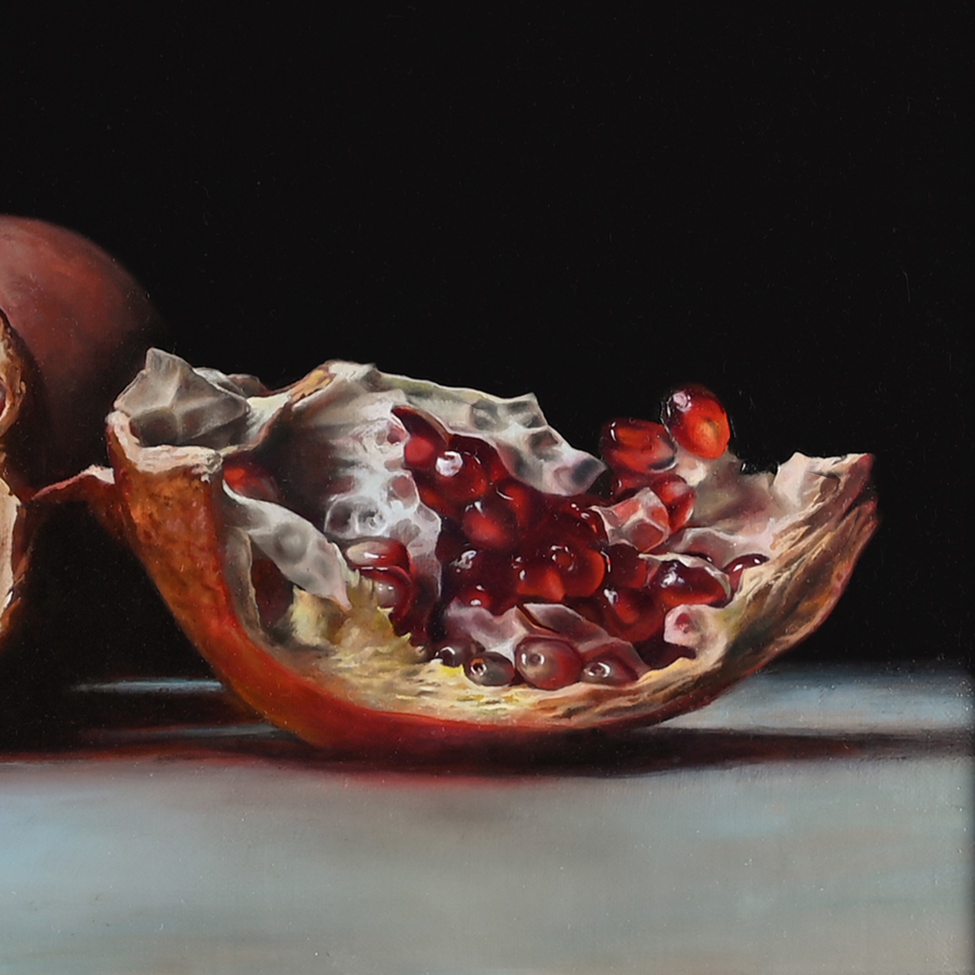 Photorealistic oil painting "Broken Hearts" by Victoria Novak, depicting several broken pomegranates on a white surface against a black background, showcasing the vibrant red arils and intricate textures.