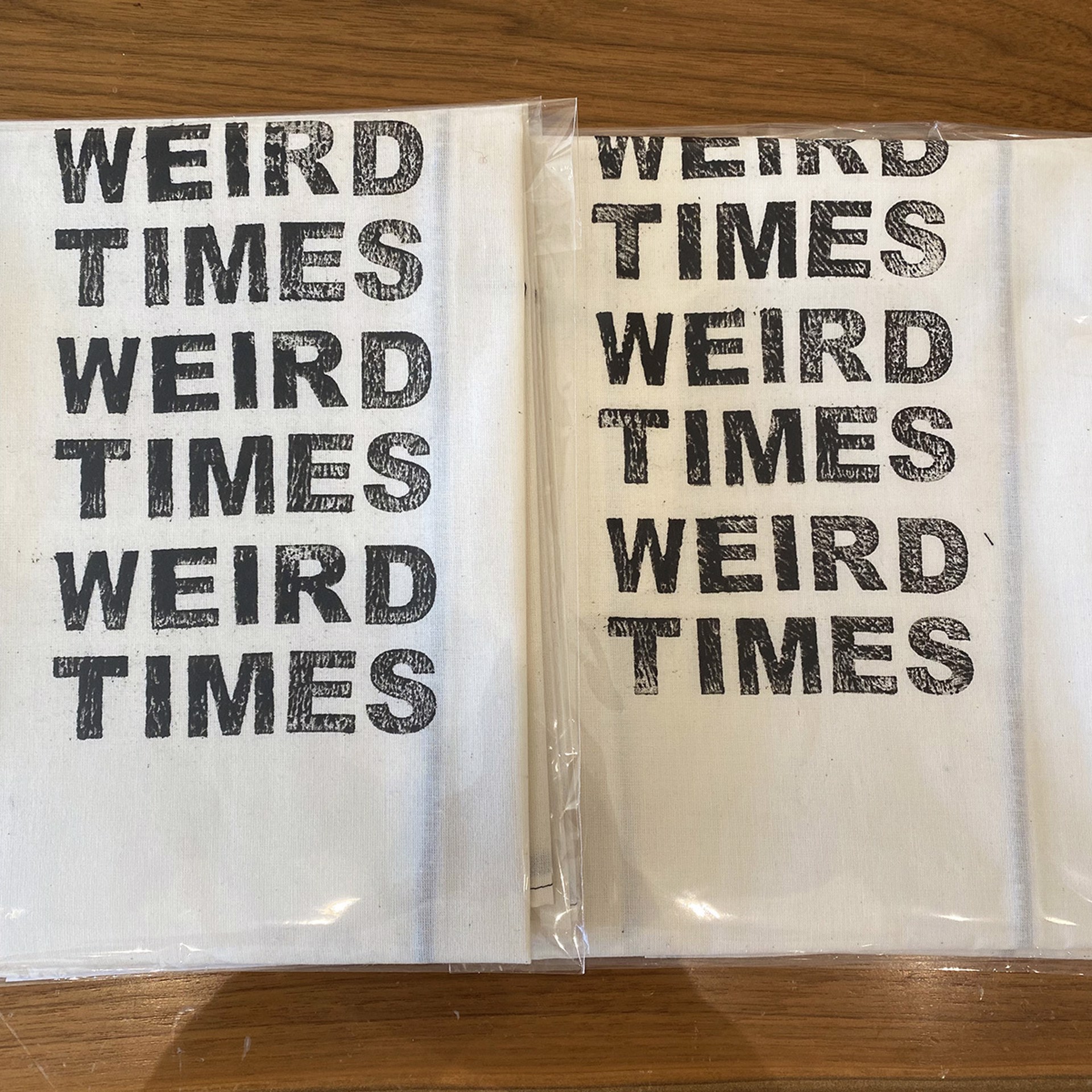 Weird Times Tea Towel, White Cotton with Black Stitching by Liz Pead