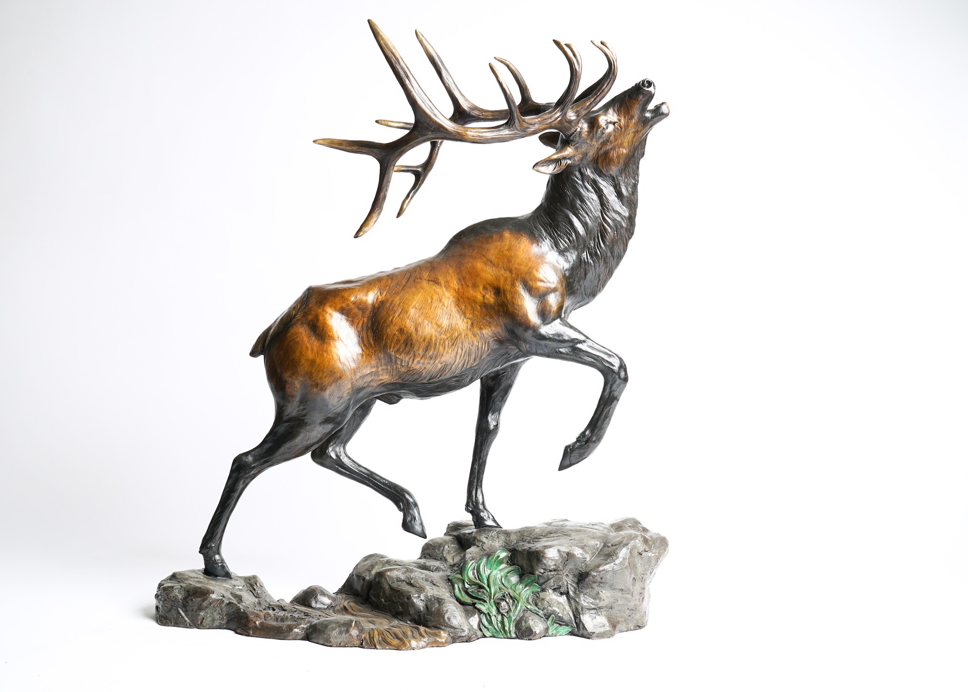 A Bronze Sculpture Of A Bull Elk With Large Antlers Bugling With Head Up Mid Step, By Rip And Alison Caswell