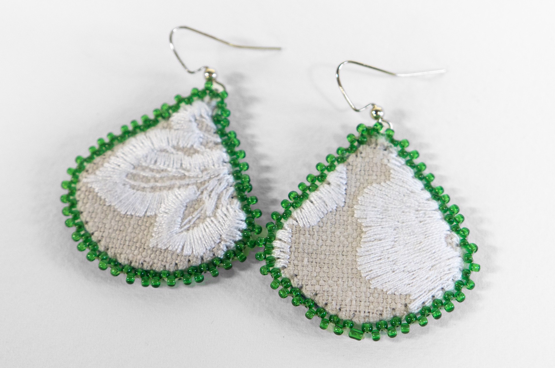 Green edge embroidered earrings by Hattie Lee Mendoza